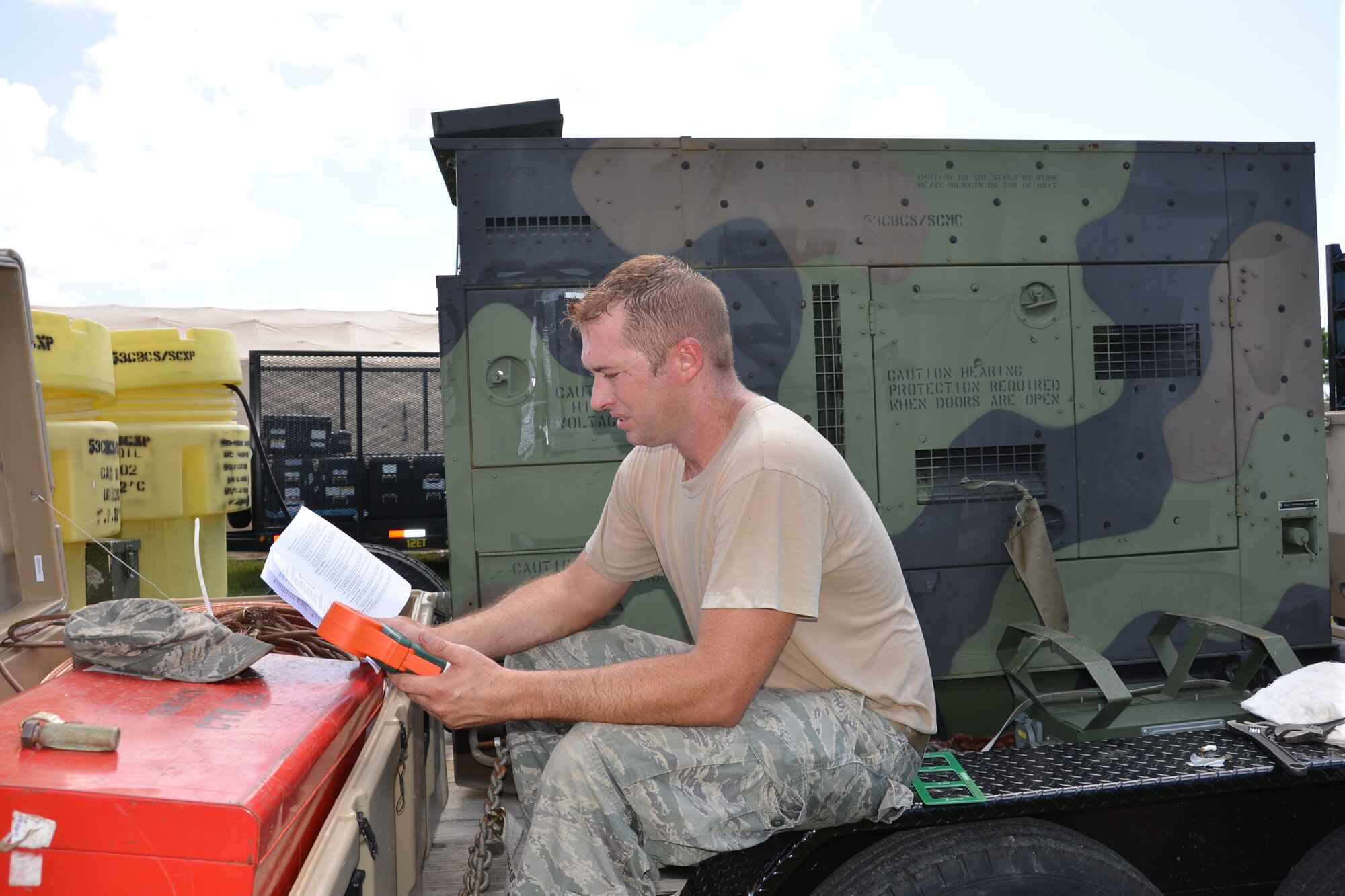 Tech. Sgt. Barry Stollar, an electrical power production craftsman, checks readings from a generator prior to a demonstration. The generator helps power  the communications equipment used by the 5th Combat Communications Group. U.S. Air Force photo by Mary McHale