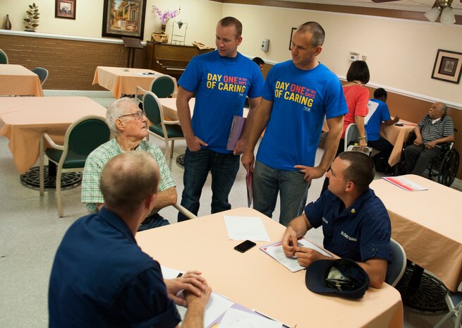 U.S. Coastguardsmen from Joint Base Charleston interview George Nelson, U.S. Coastguard veteran, during the Day of Caring September 6, 2013 at Mt. Pleasant Manor, Mt. Pleasant, S.C. Approximately 2,500 service members from JB Charleston participated in the Day of Caring, volunteering their skills to assist with more than 50 projects in the local community. The base held their volunteer events a week earlier than Trident United Way's Day of Caring, due to events surrounding the delivery of the final U.S. Air Force C-17 Globemaster III.  (U.S. Air Force photo/Senior Airman Ashlee Galloway)