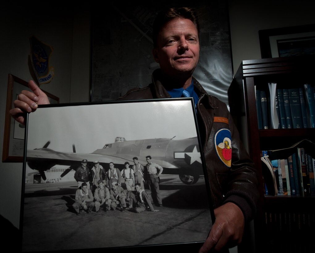 Paul Marcello, 28th Bomb Wing historian, holds a photograph taken in 1944 that includes his grandfather, Alfred Marcello, and his B-17 aircrew. The group received its combat crew training at Ellsworth nearly 70 years ago. Studying his grandfather’s military career ultimately inspired Marecello to become Ellsworth’s historian. (U.S. Air Force photo by Airman 1st Class Alystria Maurer/Released)