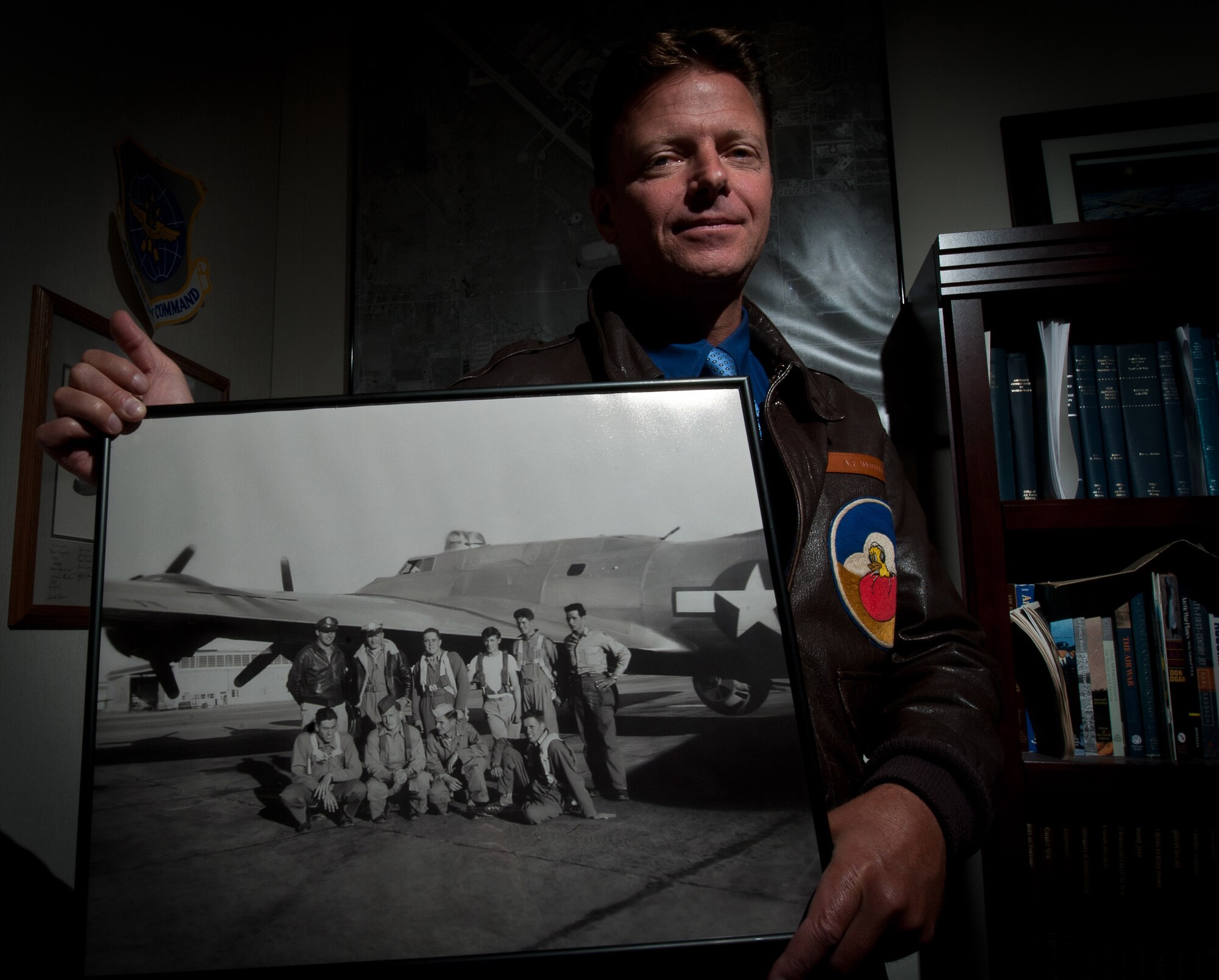Paul Marcello, 28th Bomb Wing historian, holds a photograph taken in 1944 that includes his grandfather, Alfred Marcello, and his B-17 aircrew. The group received its combat crew training at Ellsworth nearly 70 years ago. Studying his grandfather’s military career ultimately inspired Marecello to become Ellsworth’s historian. (U.S. Air Force photo by Airman 1st Class Alystria Maurer/Released)