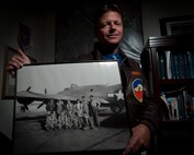 Paul Marcello, 28th Bomb Wing historian, holds a photograph taken in 1944 that includes his grandfather, Alfred Marcello, and his B-17 aircrew. The group received its combat crew training at Ellsworth nearly 70 years ago. Studying his grandfather’s military career ultimately inspired Marecello to become Ellsworth’s historian. (U.S. Air Force photo by Airman 1st Class Alystria Maurer/Released)