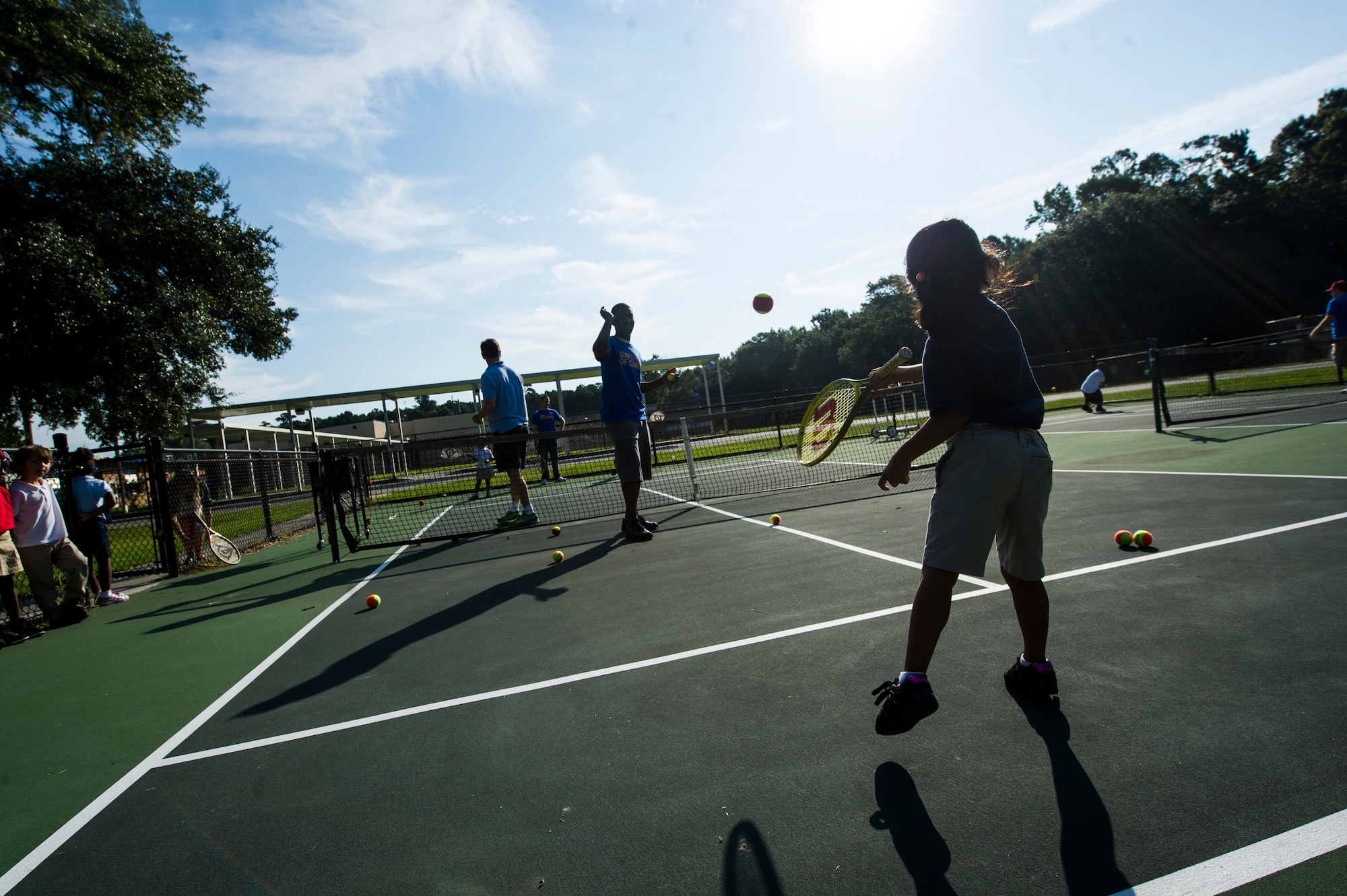 Airman 1st Class Tashma Antoine, 437th Maintenance Squadron metals technician, throws a tennis ball to a student during the Military Day of Caring Sept. 6, 2013, at Lambs Elementary School, Charleston, S.C. Approximately 2,500 service members from JB Charleston participated in the Day of Caring, volunteering their skills to assist with more than 50 projects in the local community. The base held their volunteer events a week earlier than Trident United Way's Day of Caring, due to events surrounding the delivery of the final U.S. Air Force C-17 Globemaster III.   (U.S. Air Force photo/ Senior Airman George Goslin)