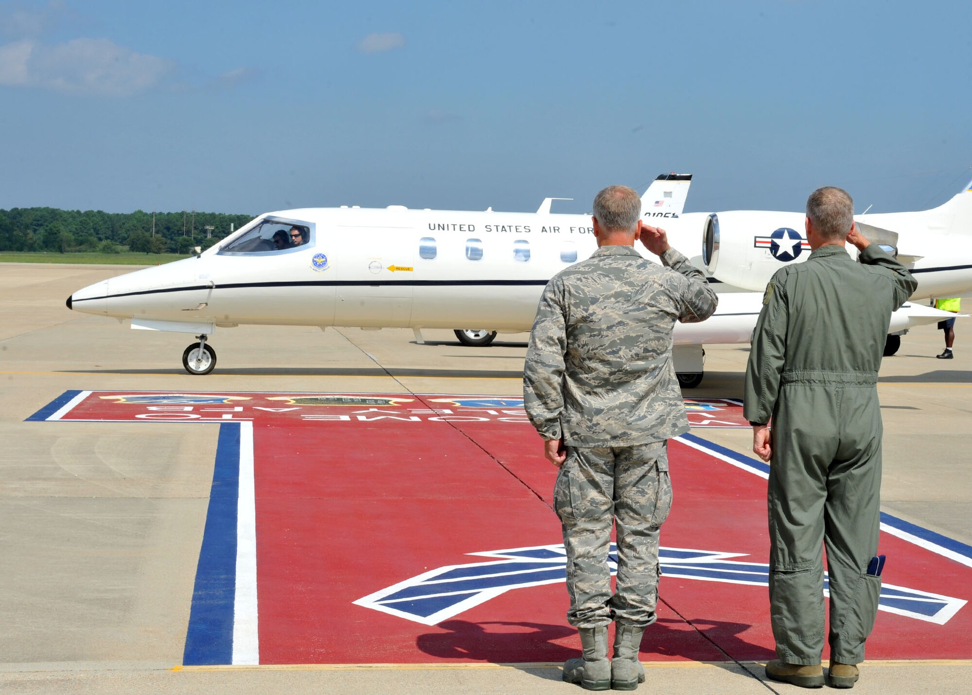 From right, Gen. Mike Hostage, Air Combat Command commander, and Col. John Allen, 633rd Air Base Wing commander, salute as Acting Secretary of the Air Force Eric K. Fanning departs Langley Air Force Base, Va., Sept. 5, 2013. Fanning toured the 94th Fighter Squadron, the 497th Intelligence, Surveillance and Reconnaissance Wing, and the Air Force Targeting Center. Additionally, Fanning spoke to Langley Airmen about current Air Force issues, including sequestration, sexual assault prevention and force shaping. (U.S. Air Force photo by Staff Sgt. Katie Gar Ward/Released)