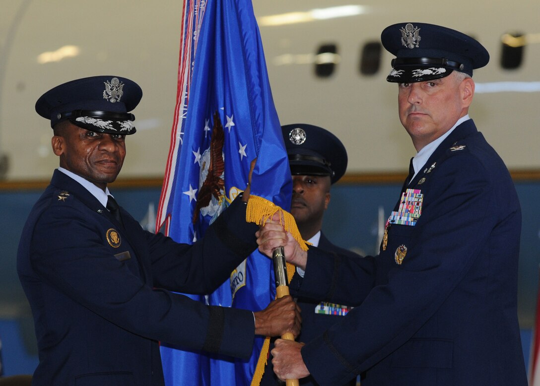 Col. Michael A. Minihan, right, relinquishes command to Lt. Gen. Darren W. McDew at the 89th Airlift Wing Change of Command on Joint Base Andrews, Md., Sept. 6, 2013. McDew, the commander of the 18th Air Force presided of the ceremony. (U.S. Air Force photo/Airman 1st Class Aaron Stout) 