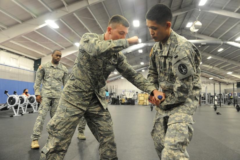 Staff Sgt. Colin Meizel, center, demonstrates weapons takeaway techniques to U.S. Army Sgt. Frankie Chan, right, and Sgt. Myles Covington, during a Fly Away Security Team course, at Joint Base Andrews, Md., Sept. 4. The course trains service members the tools and techniques to secure aircrafts globally. Both Soldiers are from the 212th Military Police Detachment at Fort Belvoir, Md.,  while Meizel is assigned to the 811th Security Forces Squadron executive aircraft security here. (U.S. Air Force Photo/Airman 1st Class Joshua R. M. Dewberry)