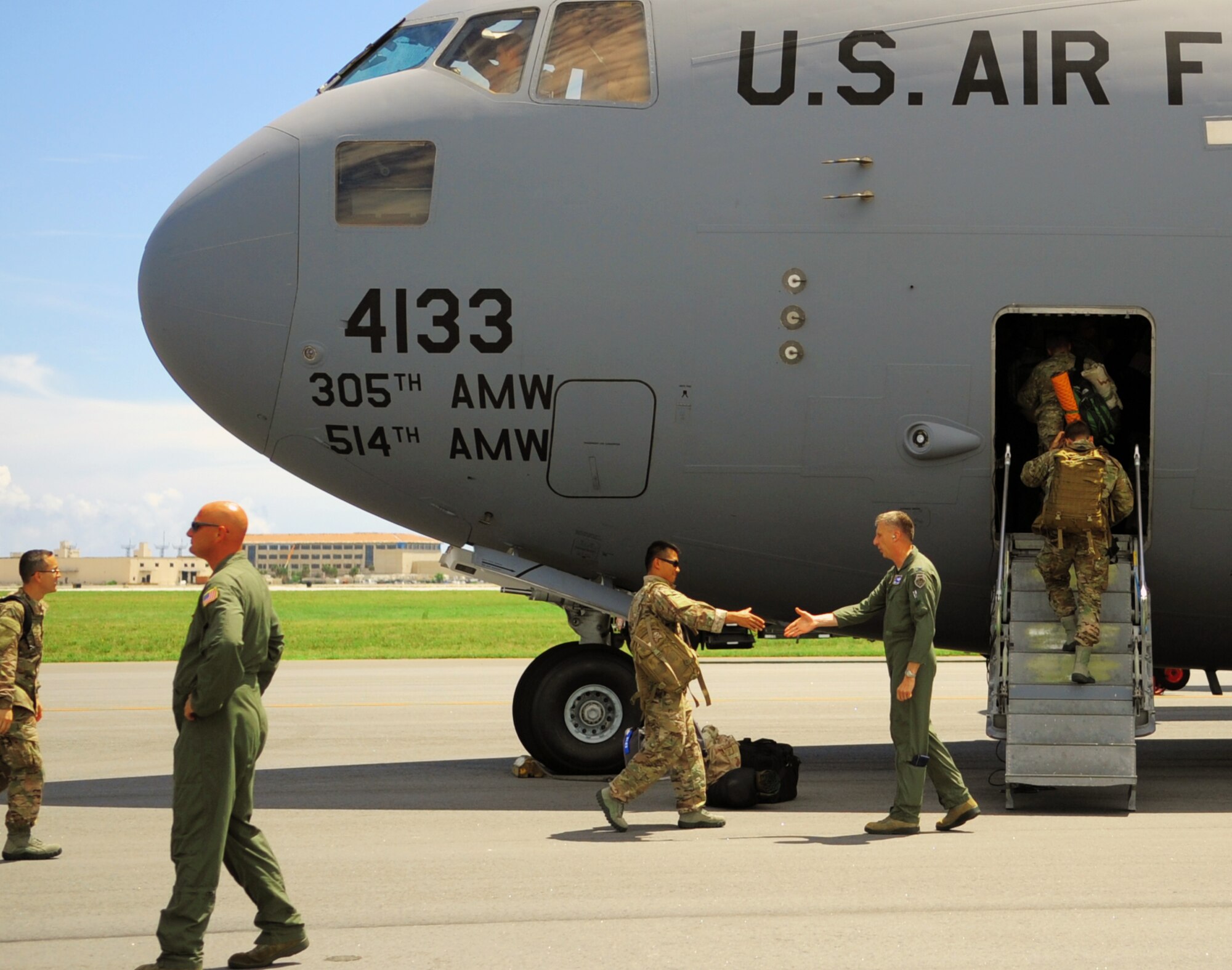 PATRICK AIR FORCE BASE, Fla. -- A group of reservists from the 920th Rescue Wing here deploy to the Horn of Africa Sept. 5 for contingency support there. Approximately 20 pararescuemen and various support personnel from the 920th deployed in a C-17 Globemaster from the 514th Air Mobility Wing at Joint Base McGuire-Dix-Lakenhurst, N.J. The PJs will serve as part of the Combined Joint Task Force-Horn of Africa and will be in place for personnel-recovery operations along with humanitarian efforts as needed. The deployment comes as one of many for Airmen of the 920th RQW. Roughly 40 Rescue Wing Airmen are currently deployed to Southeast Asia providing life-saving medical evacuations of combatants wounded on the battlefield. Seen here, wing commander Col. Jeffrey Macrander sees his Airmen off as they depart. Air Force pararescuemen are specifically organized, trained and equipped to conduct personnel recovery operations in hostile or denied areas as a primary mission. (U.S. Air Force photo/Master Sgt. Paul Flipse)