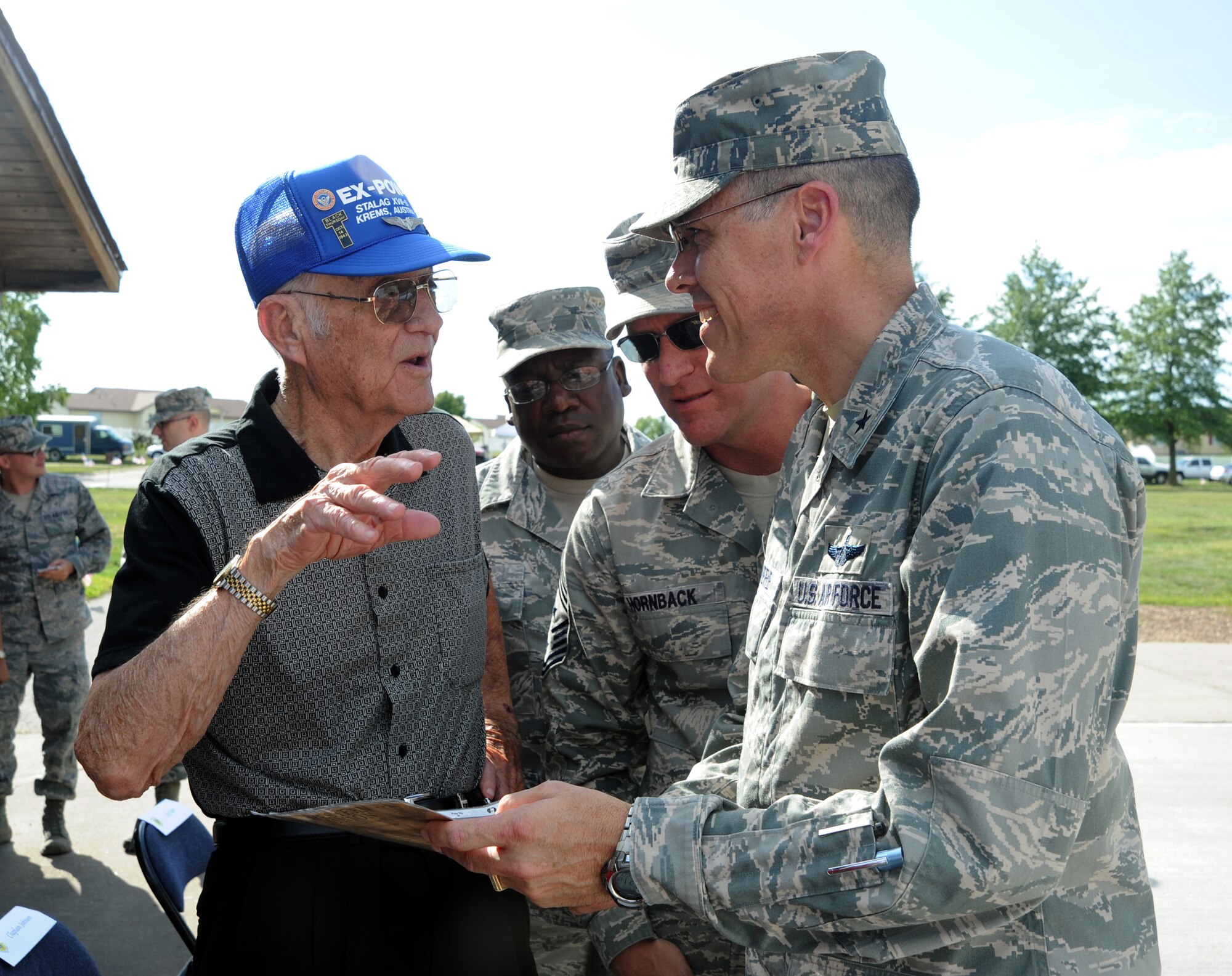 Retired U.S. Air Force Chief Master Sgt. Charles Seibert, left, talks to U.S. Air Force Brig. Gen. Thomas A. Bussiere, 509th Bomb Wing commander, about his experiences as a prisoner of war during World War II, Sept. 5, 2013, at Whiteman Air Force Base, Mo. Seibert served as a B-17 Flying Fortress tail gunner during World War II before spending 548 days as a POW. (U.S. Air Force photo by Staff Sgt. Brigitte N. Brantley/Released)