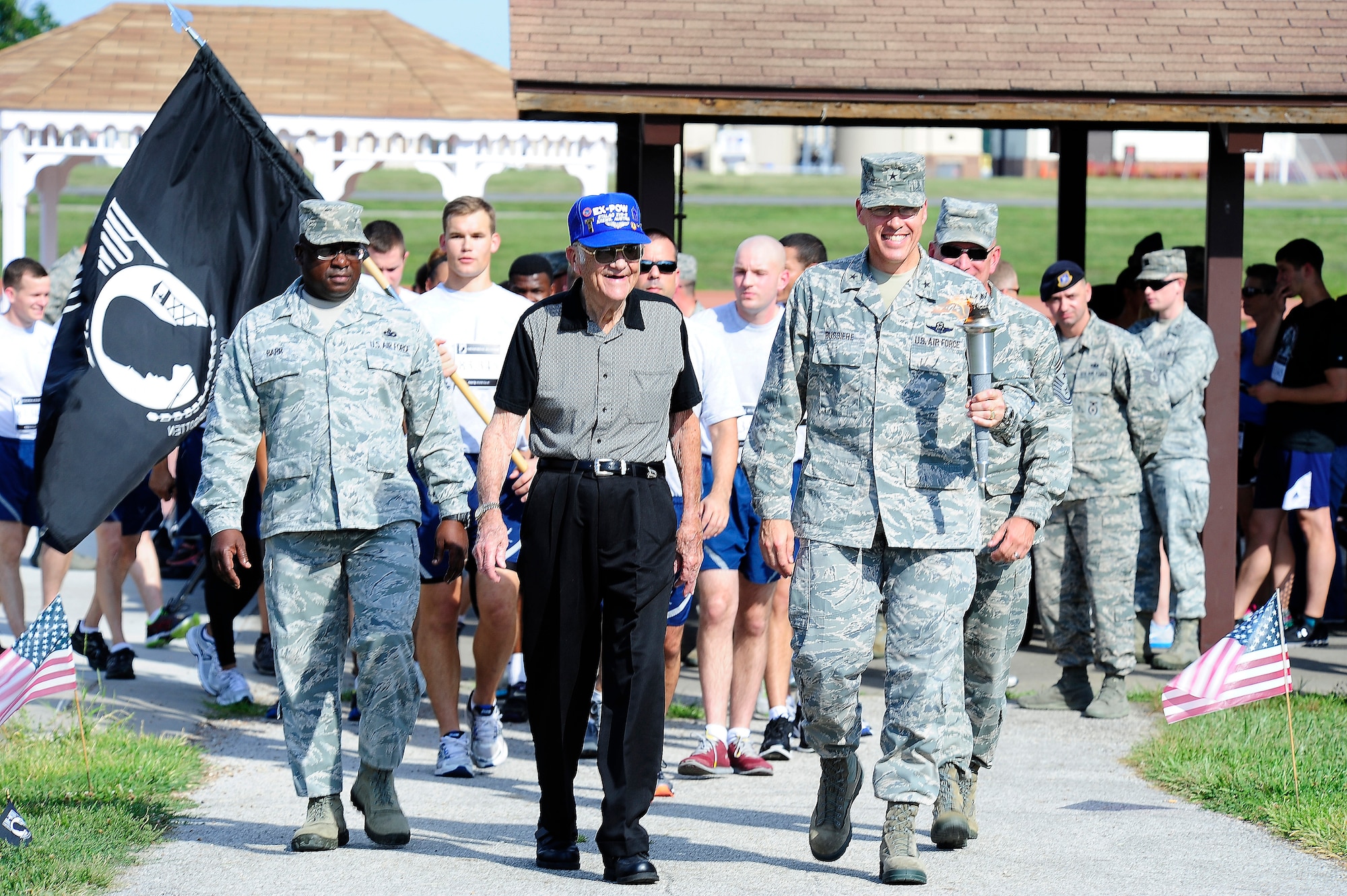 Retired U.S. Air Force Chief Master Sgt. Charles Seibert, center, walks next to U.S. Air Force Brig. Gen. Thomas A. Bussiere, left, 509th Bomb Wing commander, and Chief Master Sgt. Lee Barr, 509th BW command chief, during a prisoner of war and missing in action remembrance ceremony Sept. 5, 2013, at Whiteman Air Force Base. Seibert served as a B-17 Flying Fortress tail gunner during World War II before spending 548 days as a POW. (U.S. Air Force photo by Staff Sgt. Brigitte N. Brantley/Released)