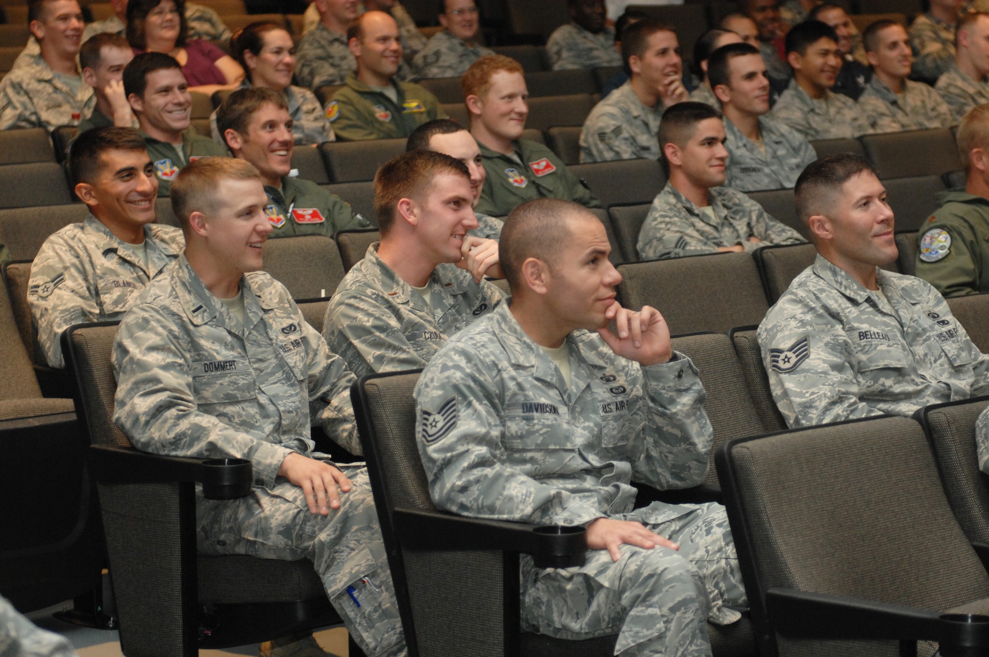 Members of Team Seymour laugh during the 4th Fighter Wing Leadership Lecture Series: The Freak Factor, at Seymour Johnson Air Force Base, N.C., Sept. 5, 2013. Rendall told personal stories which gave insight to what makes him different and how his dissimilarities added to his success. (U.S. Air Force photo by Airman 1st Class Brittain Crolley)