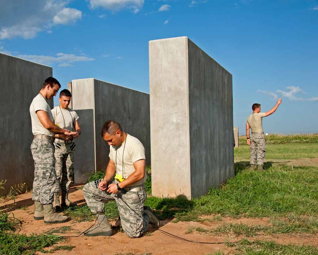 U.S. Air Force Airman Steven Benton, Kevin Oseguera, Airman 1st Class Kevin Reese and Airman Adam Allen, 366th Training Squadron, Explosive Ordnance Disposal course is performing closed/open/closed to check the continuity of their firing systems in preparation to set off C-4 explosives on August 26, 2013 at Sheppard Air Force Base, Texas. (U.S. Air Force photo by Frank Carter/Released)

