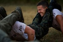 Travis Taylor does pushups with his teammates during Rescue Athlete training clinic Aug. 24 at Joint Base San Antonio-Lackland. The RA clinic tests the physical and psychological performance of each participant through proven battle tested methods. (U.S. Air Force photo/Staff Sgt. Jonathan Snyder)