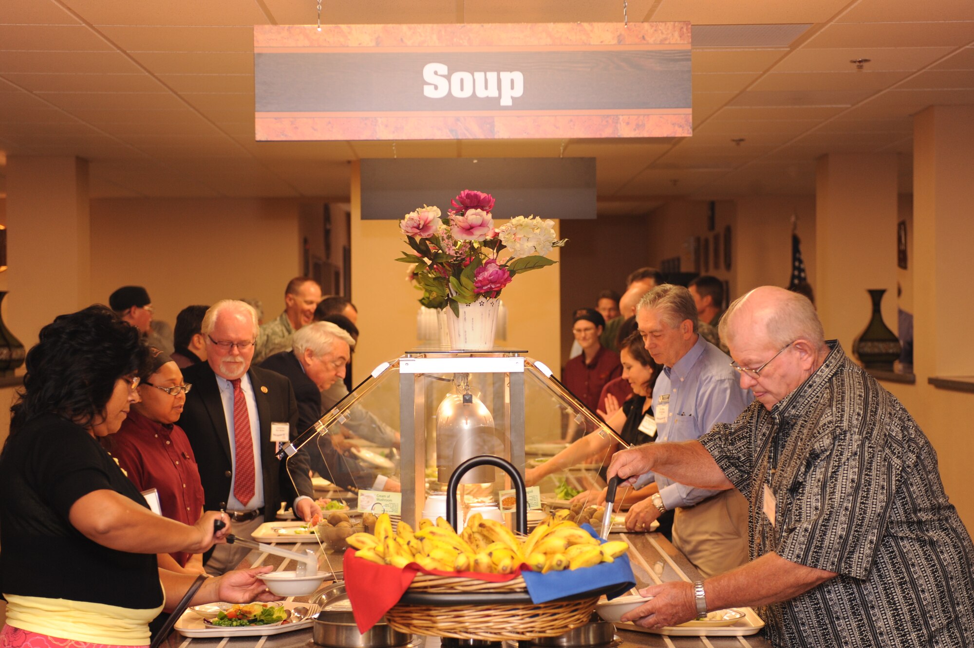 The Centers for Habilitation employees enjoy buffet-style lunch during the 20th Anniversary celebration honoring their partnership with Davis-Monthan Air Force Base Aug. 19, 2013.  Currently, 80 TCH employees prepare and serve food at the Desert Dining Inn and Roadrunner Kitchen on base. (U.S. Air Force photo
by Airman 1st Class Chris Massey/Released)