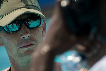 Chief Master Sgt. Doug Isaacks, Pararescue Indoctrination Course commandant, instructs participants on proper buddy breathing during the water confidence portion of the Rescue Athlete training clinic Aug. 24 at Joint Base San Antonio-Lackland. (U.S. Air Force photo/Staff Sgt. Jonathan Snyder)