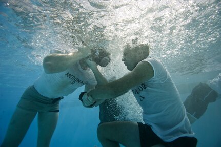 Steven McDonald, left, and Travis Taylor, right, practice buddy breathing during water confidence portion of the Rescue Athlete training clinic Aug. 24 at Joint Base San Antonio-Lackland. (U.S. Air Force photo/Staff Sgt. Jonathan Snyder)