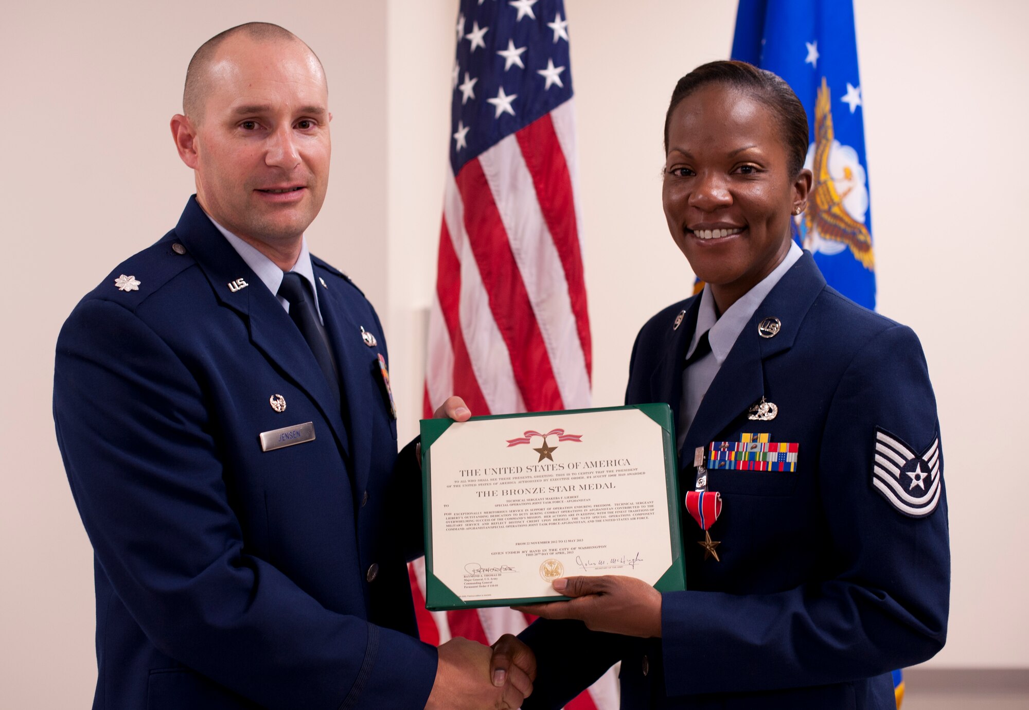 U.S. Air Force Lt. Col. Todd Jensen, 366th Logistics Readiness Squadron commander, presents Tech. Sgt. Makeba Liebert, 366th LRS NCO in charge of individual protection equipment, the Bronze Star Medal at Mountain Home Air Force Base, Idaho, Aug. 29, 2013. The Bronze Star is the fourth highest combat medal in the U.S. (U.S. Air Force photo by Airman 1st Class Malissa Lott/ Released)