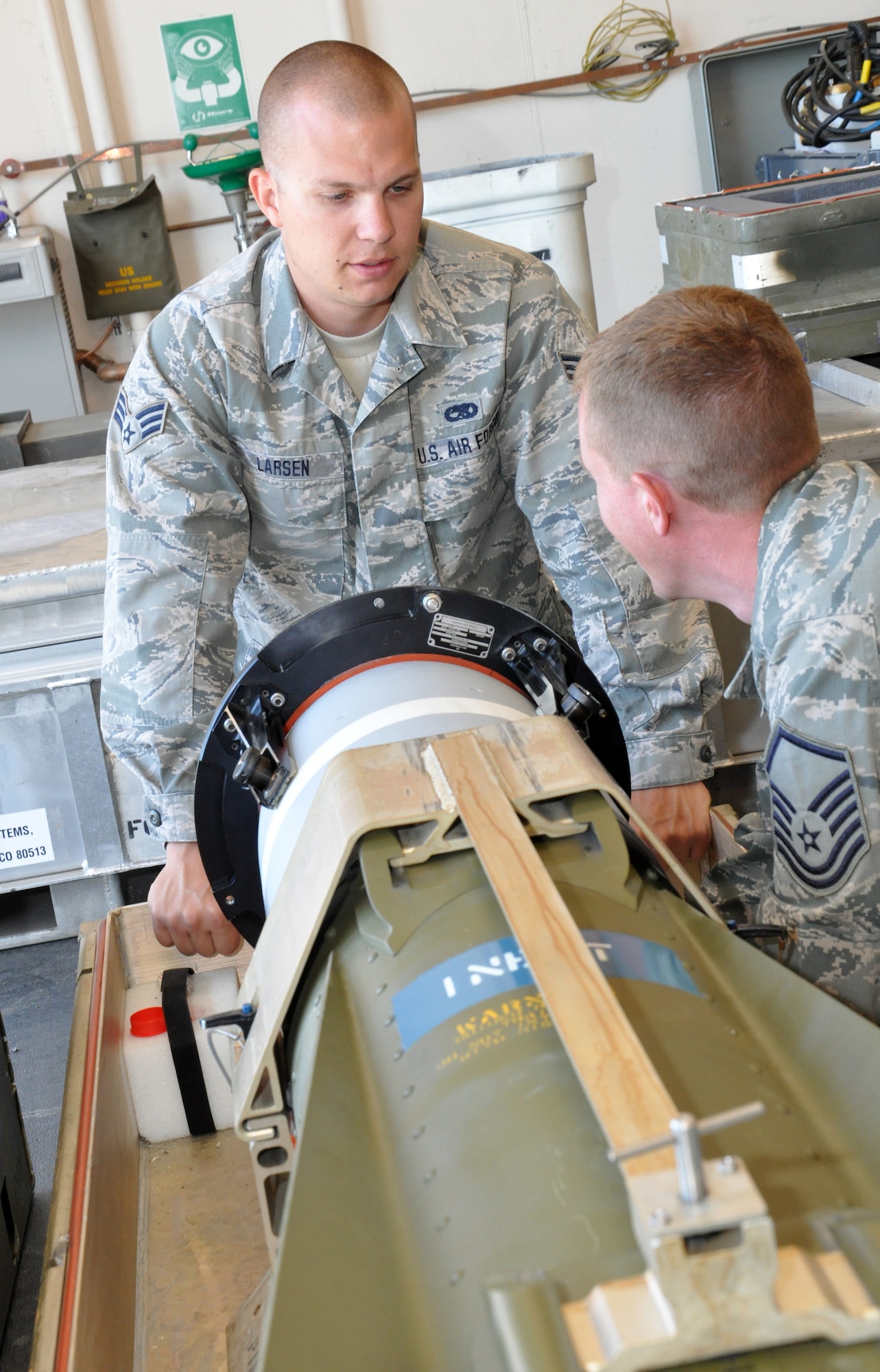 Senior Airman Dylan Larsen, 140th Wing precision guided munitions crew member, left, works with Master Sgt. Bradley Mercil, 140th Wing production superintendent, to test an AGM-65 Maverick missile Aug. 2, 2013, on Buckley Air Force Base, Colo. The AGM-65 is designed as an air-to-ground weapon system used on the F-16 Fighting Falcons. The 140th Wing handles the munitions needs of units across the Front Range. (U.S. Air Force photo by Staff Sgt. Nicholas Rau/Released)