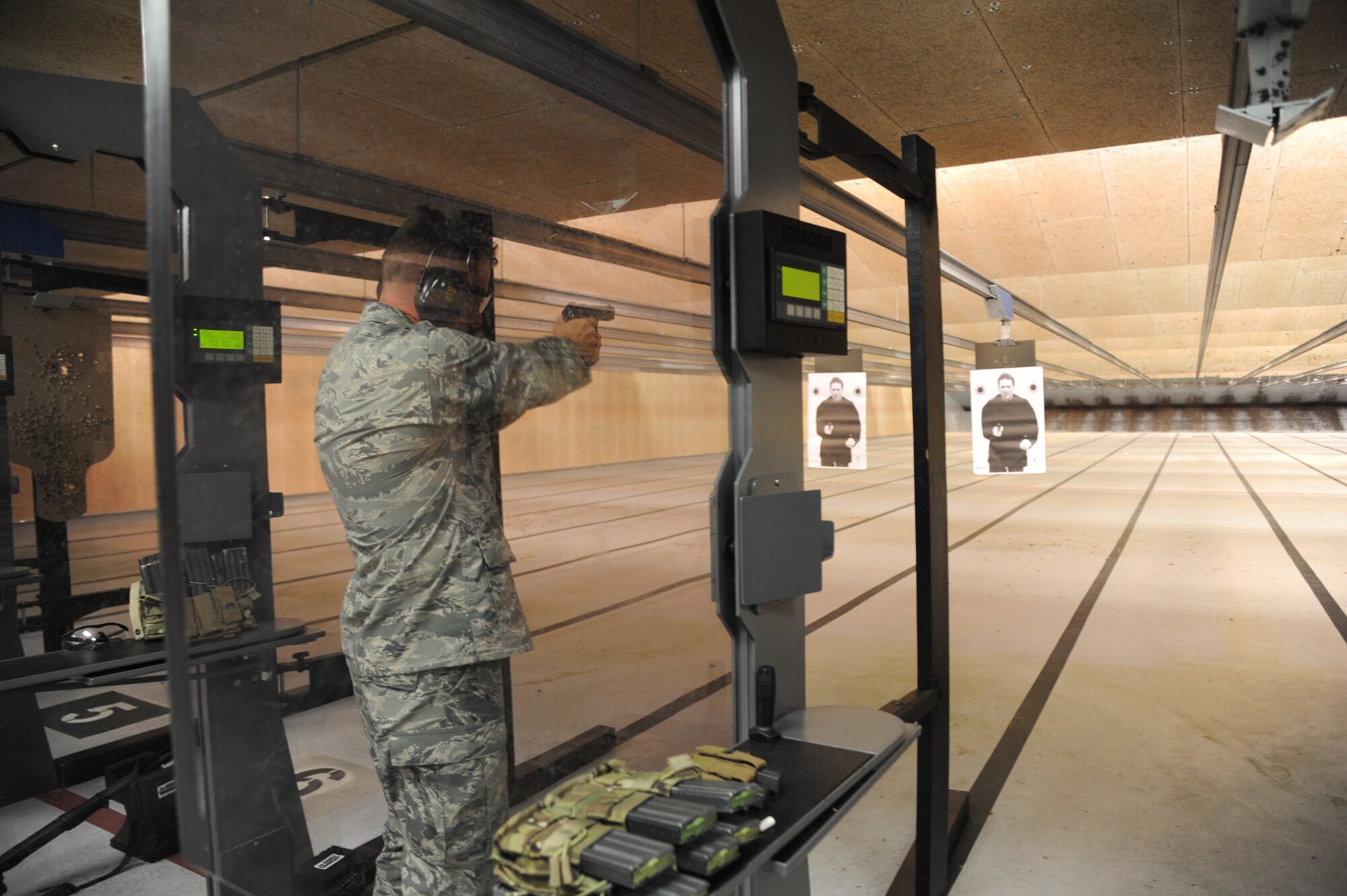 Brig. Gen. Patrick Higby, 81st Training Wing commander, fires at a target while touring the 81st Security Forces Squadron indoor firing range during an immersion tour of the 81st Mission Support Group Sept. 4, 2013, at Keesler Air Force Base, Miss. The purpose of the tour was to learn the integration of the group operations and personnel.  (U.S. Air Force photo by Kemberly Groue)