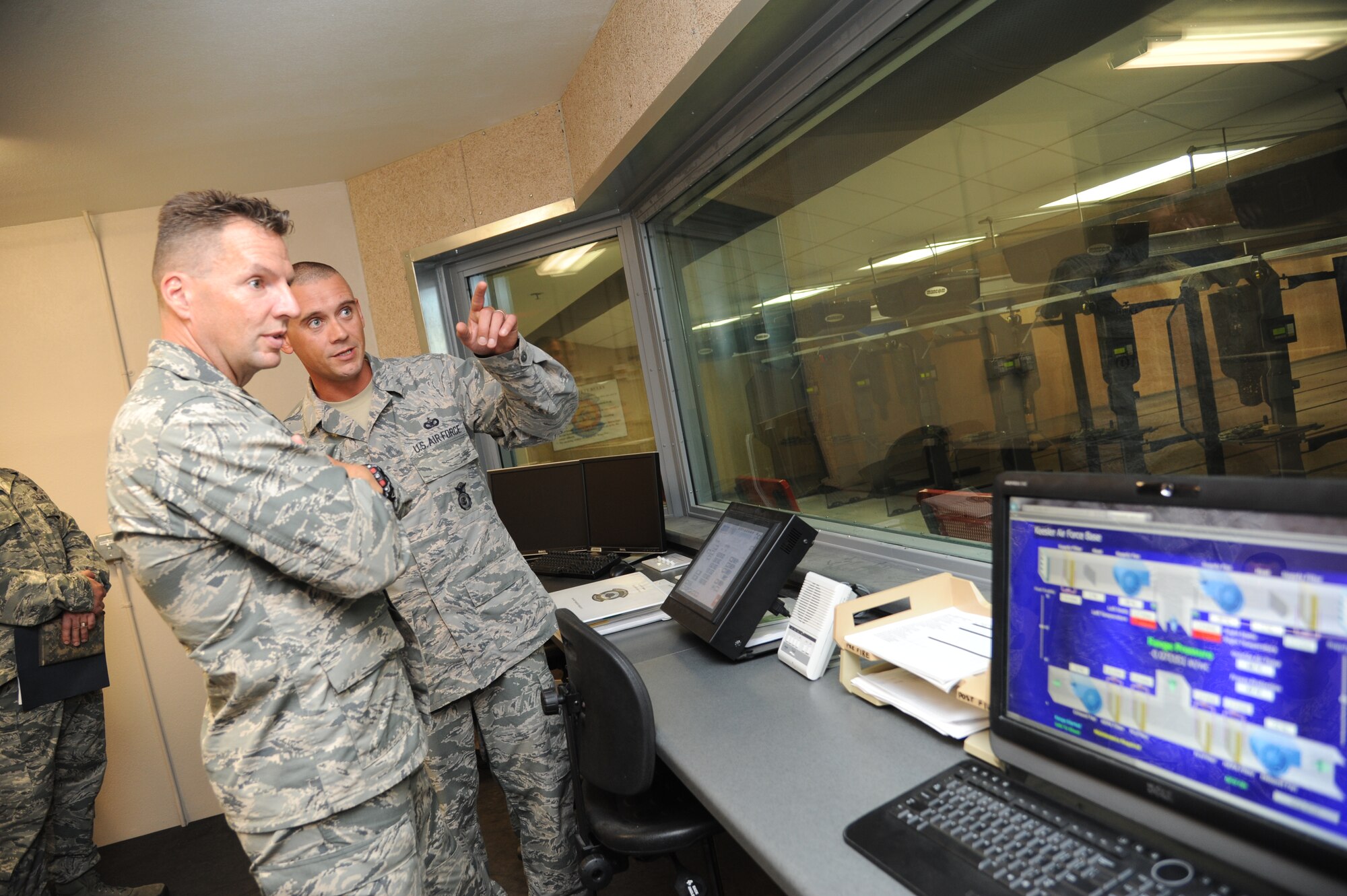 Brig. Gen. Patrick Higby, 81st Training Wing commander, is briefed by Tech. Sgt. Jonathan Johnson, 81st Security Forces Squadron, on the capabilities of the indoor firing range during an immersion tour of the 81st Mission Support Group Sept. 4, 2013, at Keesler Air Force Base, Miss. The purpose of the tour was to learn the integration of the group operations and personnel.  (U.S. Air Force photo by Kemberly Groue)