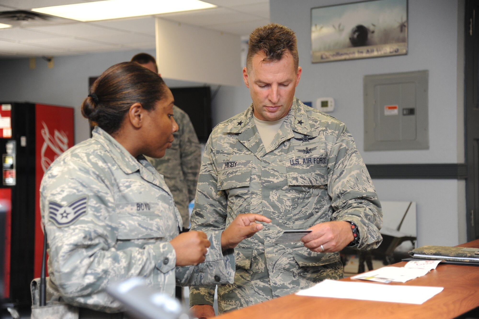 Staff Sgt. Wahkina Boyd, 81st Security Forces Squadron, shows a falsified civilian identification card to Brig. Gen. Patrick Higby, 81st Training Wing commander, as a demonstration of visitor center procedures during an immersion tour of the 81st Mission Support Group Sept. 4, 2013, Keesler Air Force Base, Miss. The purpose of the tour was to learn the integration of the group operations and personnel.  (U.S. Air Force photo by Kemberly Groue)