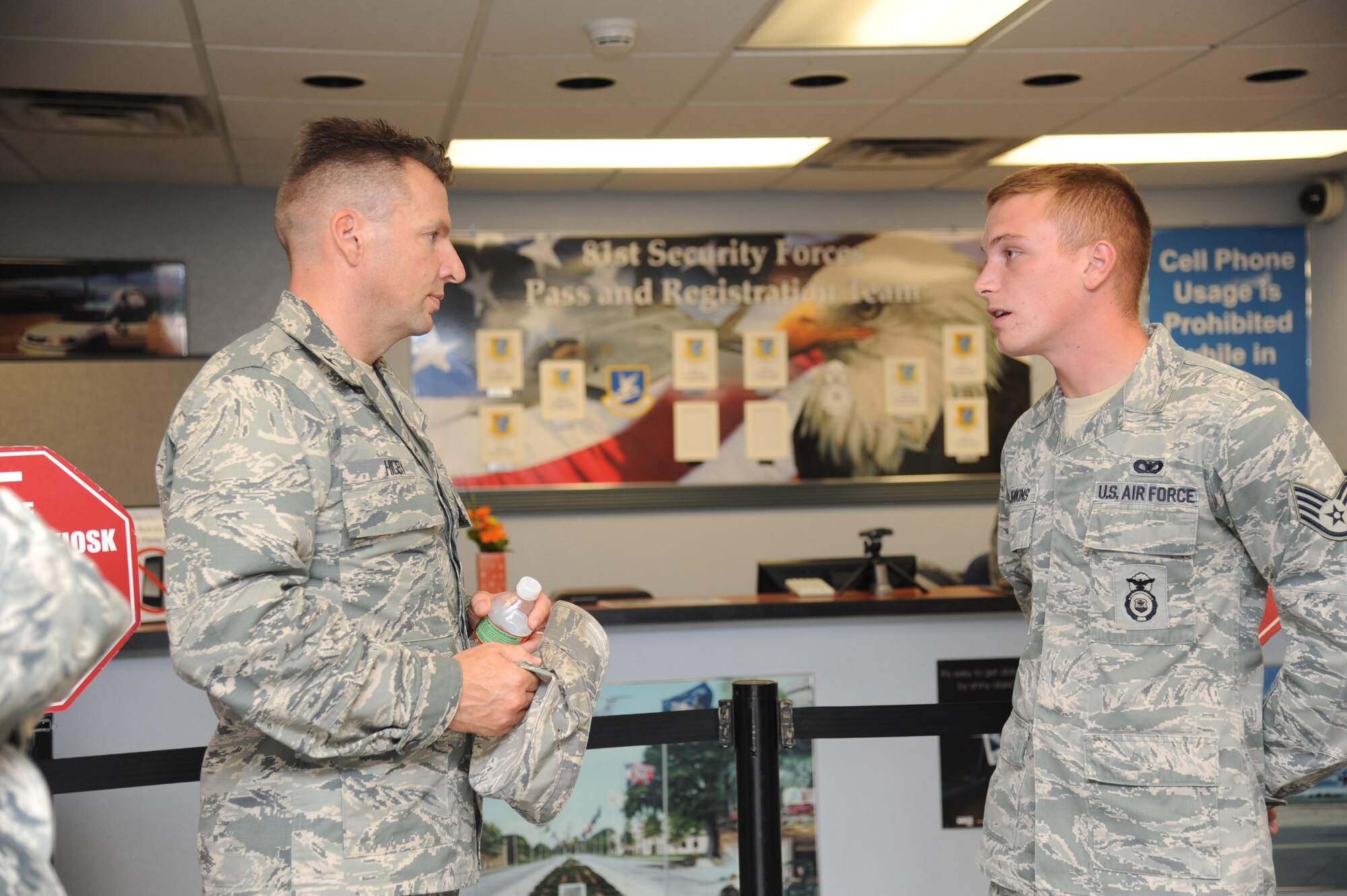 Brig. Gen. Patrick Higby, 81st Training Wing commander, receives an overview of the pass and registration office from Staff Sgt. Bradley Jenkins, 81st Security Forces Squadron, during an immersion tour of the 81st Mission Support Group Sept. 4, 2013, at the visitors center, Keesler Air Force Base, Miss. The purpose of the tour was to learn the integration of the group operations and personnel.  (U.S. Air Force photo by Kemberly Groue)