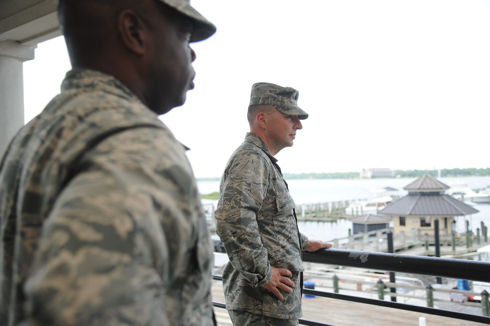 Col. Mark Vivians, 81st Mission Support Group commander, and Brig. Gen. Patrick Higby, 81st Training Wing commander, view the Keesler Marina from the Bay Breeze Event Center balcony during an immersion tour of the 81st Mission Support Group Sept. 4, 2013, Keesler Air Force Base, Miss. The purpose of the tour was to learn the integration of the group operations and personnel.  (U.S. Air Force photo by Kemberly Groue)