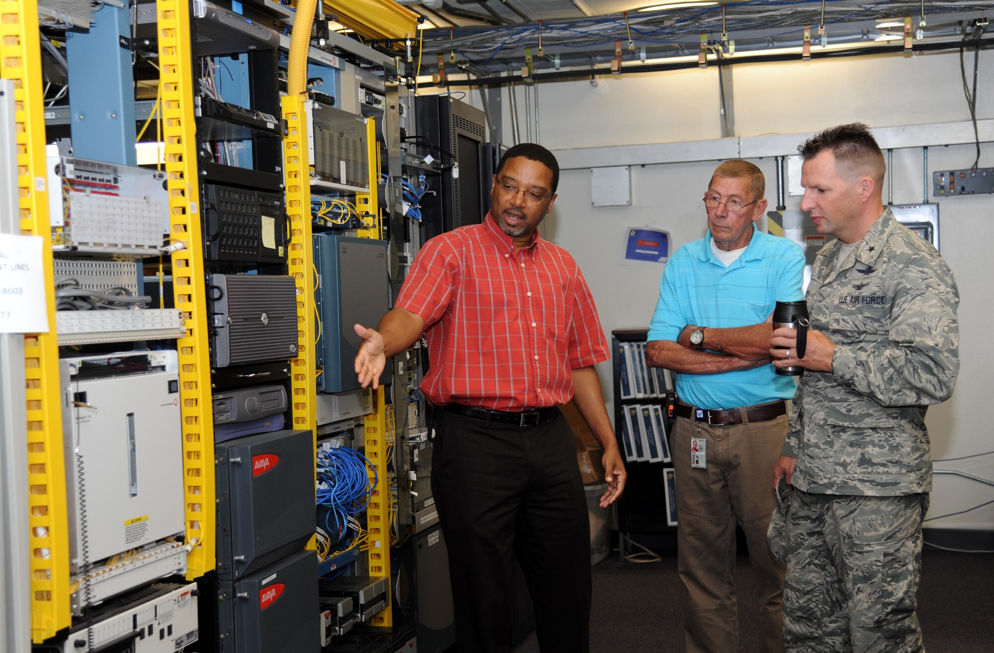 Rodney McGruder and Michael Knieriem, 81st Communications Squadron, brief Brig. Gen. Patrick Higby, 81st Training Wing commander, on base information equipment during an immersion tour of the 81st Mission Support Group Sept. 4, 2013, Keesler Air Force Base, Miss. The purpose of the tour was to learn the integration of the group operations and personnel.  (U.S. Air Force photo by Kemberly Groue)