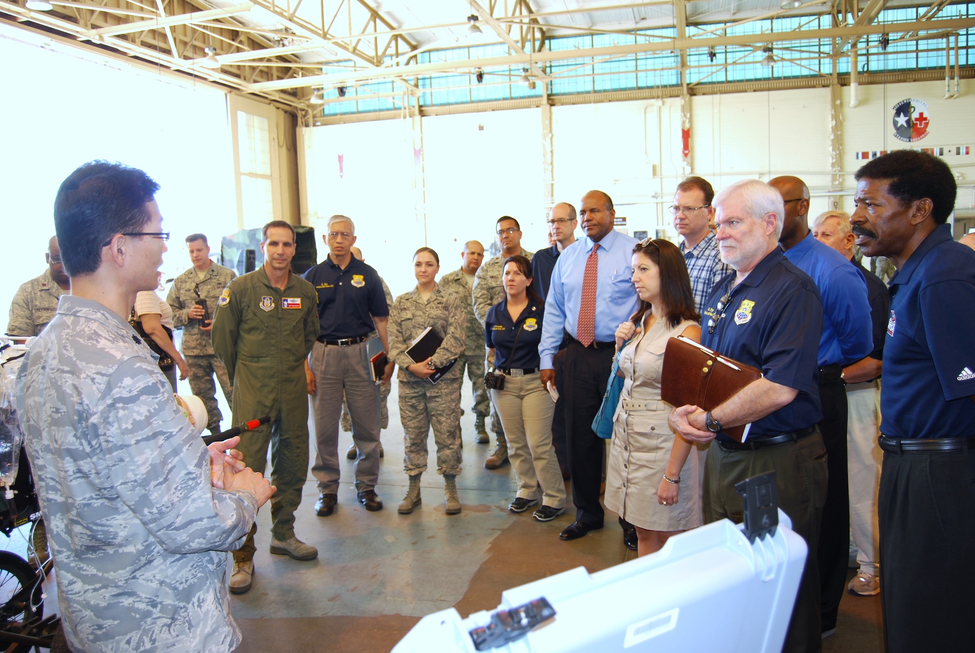 Lt. Col. Jong Lee, a 433rd Medical Squadron Critical Care Air Transport Team physician, explains to 433rd Airlift Wing's Honorary Commanders how ill or injured patients are transported during the "Alamo Wing's" medical mission tour on Sept. 5, 2013 on Joint Base San Antonio-Lackland. The CCATT is a mobile intensive-care unit that keeps the patient stable until further treatment is provided at a higher echelon of care. (U.S. Air Force Photo/ Ms. Elsa Martinez)