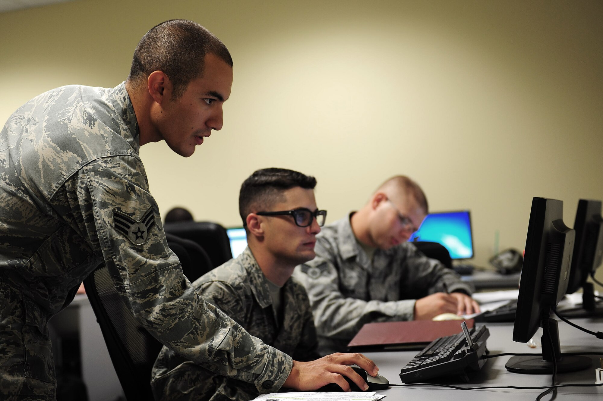 Senior Airman Ariel Fischer, 39th Comptroller Squadron finance customer service technician, helps Airmen in-process Sept. 9, 2013, at Incirlik Air Base, Turkey.  In order to best serve all Incirlik AB personnel and families, customer service hours at various facilities such as the post office, Military Personnel Section and finance office, changed Aug. 12. (U.S Air Force photo by Airman 1st Class Nicole Sikorski/Released) 
