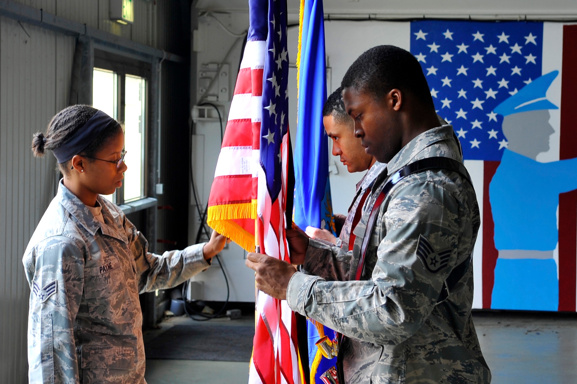 Members of the Ramstein honor guard receive instructions on the proper way to place flags in their stands, July 10, 2013, Ramstein Air Base, Germany. The base honor guard trains for three hours a week for various types of ceremonies. (U.S. Air Force photo/Airman 1st Class Trevor Rhynes)