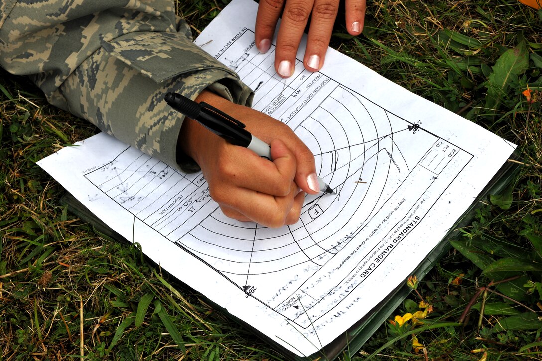 Senior Airman Ashley Fagan, 435th Aircraft Maintenance Squadron knowledge operations management, goes over a field range card during Exercise Market Orchard, Aug. 27, 2013, U.S. Army Garrison Baumholder, Germany. During the exercise a mobile response team set up an operational air base that could provide humanitarian relief. (U.S. Air Force photo/Senior Airman Chris Willis)