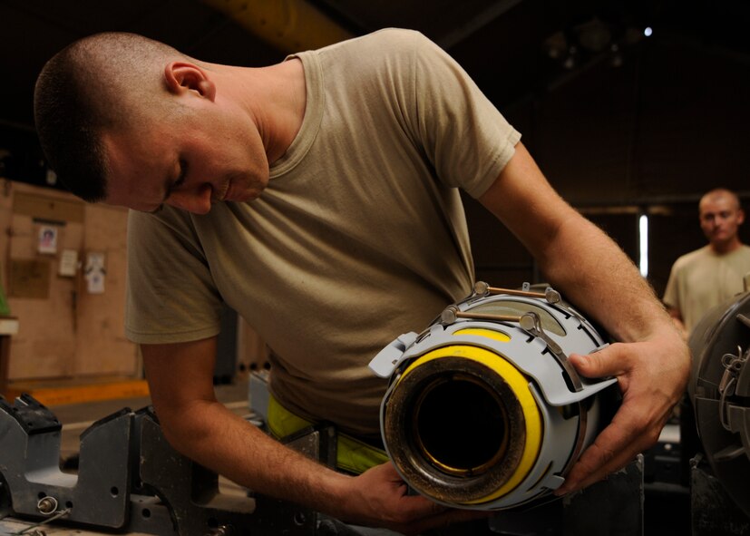 Airman 1st Class Matthew Carlson places an aerosurface assembly on a laser joint directed attack munition during a bomb build at the 379th Air Expeditionary Wing in Southwest Asia, Sept. 2, 2013. The aerosurface assembly provides aerodynamic lift, maneuverability and other necessary flight characteristics. Carlson is a 379th Expeditionary Maintenance Squadron conventional maintenance crew member deployed from Dyess Air Force Base, Texas, and a Lake Panasoffkee, Fla., native. (U.S. Air Force photo/Senior Airman Bahja J. Jones) 