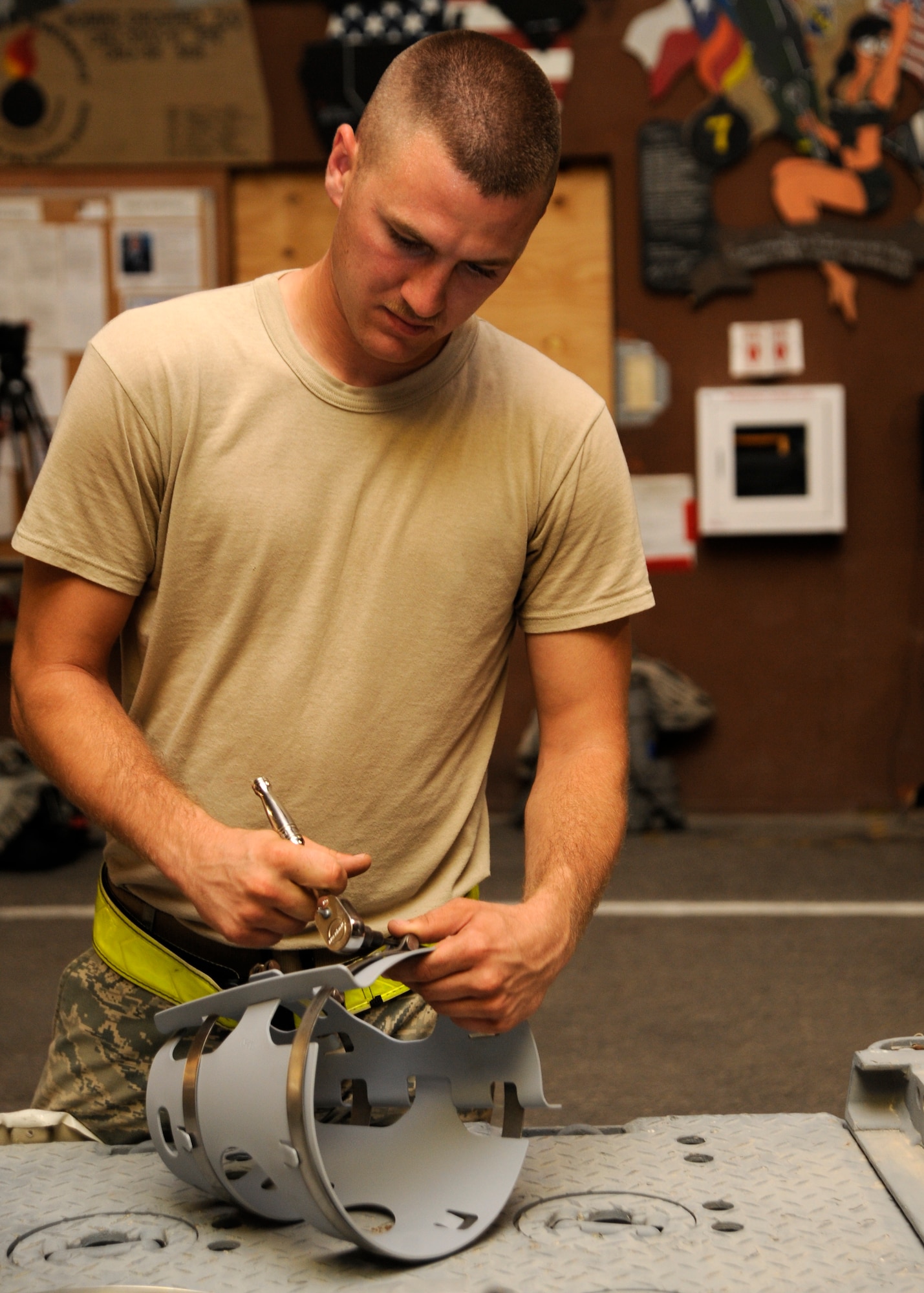 Airman 1st Class Matthew Carlson prepares an aerosurface assembly to be fitted onto a laser joint directed attack munition during a bomb build at the 379th Air Expeditionary Wing in Southwest Asia, Sept. 2, 2013. The aerosurface assembly provides aerodynamic lift, maneuverability and other necessary flight characteristics. Carlson is a 379th Expeditionary Maintenance Squadron conventional maintenance crew member deployed from Dyess Air Force Base, Texas, and a Lake Panasoffkee, Fla., native. (U.S. Air Force photo/Senior Airman Bahja J. Jones) 