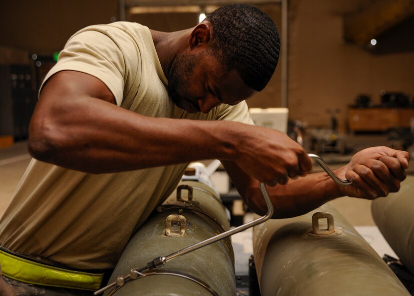 Staff Sgt. Everett Myles uses a speed handle to secure straps on a laser joint directed attack munition during a bomb build at the 379th Air Expeditionary Wing in Southwest Asia, Sept. 2, 2013. Myles is a 379th Expeditionary Maintenance Squadron conventional maintenance crew chief deployed from Dyess Air Force Base, Texas, and hails from Fort Worth, Texas. (U.S. Air Force photo/Senior Airman Bahja J. Jones) 