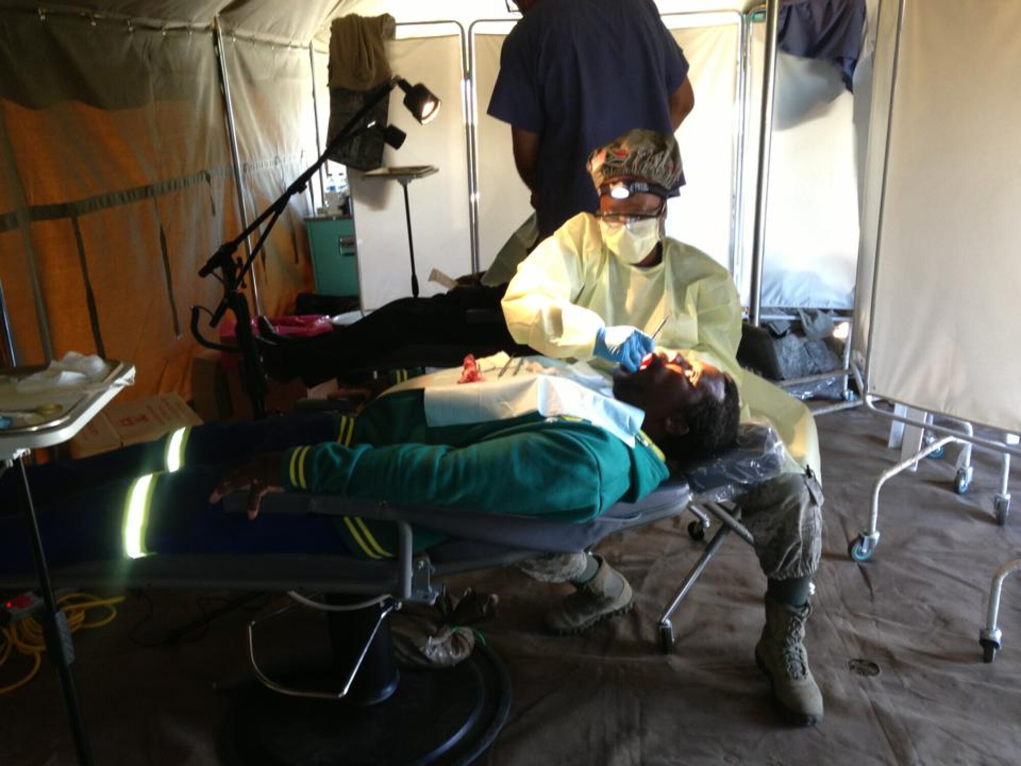 Tech. Sgt. Aretha Boston, 31st Dental Squadron logistics NCO in charge, inspects a local South African during a humanitarian mission near King Williams’ Town, South Africa, that lasted from July 21 to Aug. 8, 2013. To ensure a regular routine and combat further infections, 1,500 kits containing toothpaste, toothbrushes and floss were handed out free of charge. (Courtesy photo)