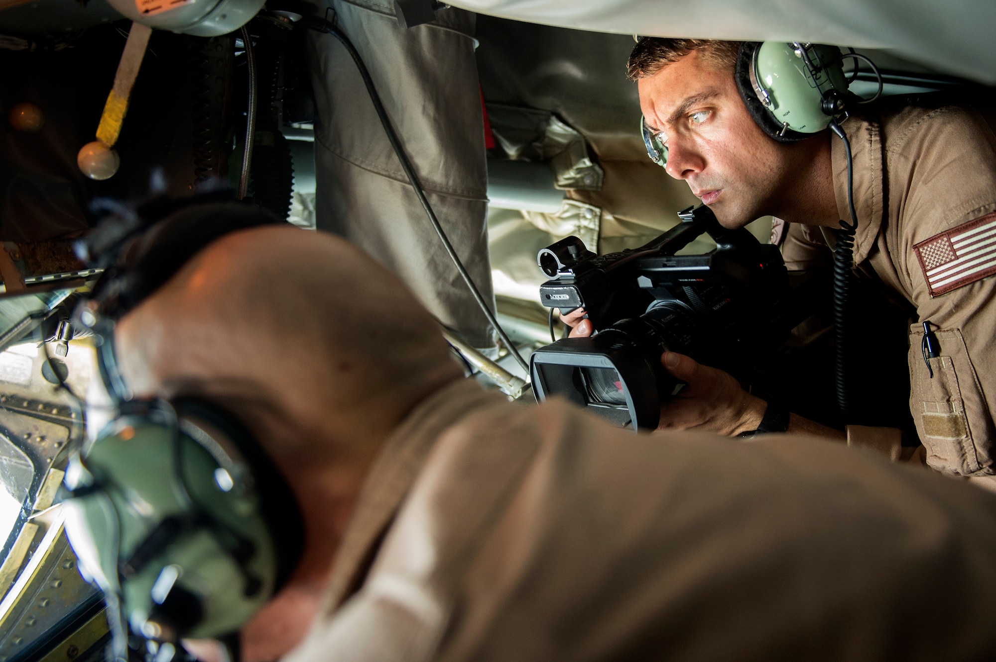 Staff Sgt. Roidan Carlson, U.S. Air Forces Central aerial combat broadcaster, documents Master Sgt. John Fidler, a KC-135R Stratotanker boom operator during a mission over the Persian Gulf, Aug. 30, 2013. Carlson, hailing from Everett, Wash., is deployed from the 2nd Combat Camera Squadron, Hill Air Force Base, Utah. (U.S. Air Force Photo/Master Sgt. Ben Bloker)
