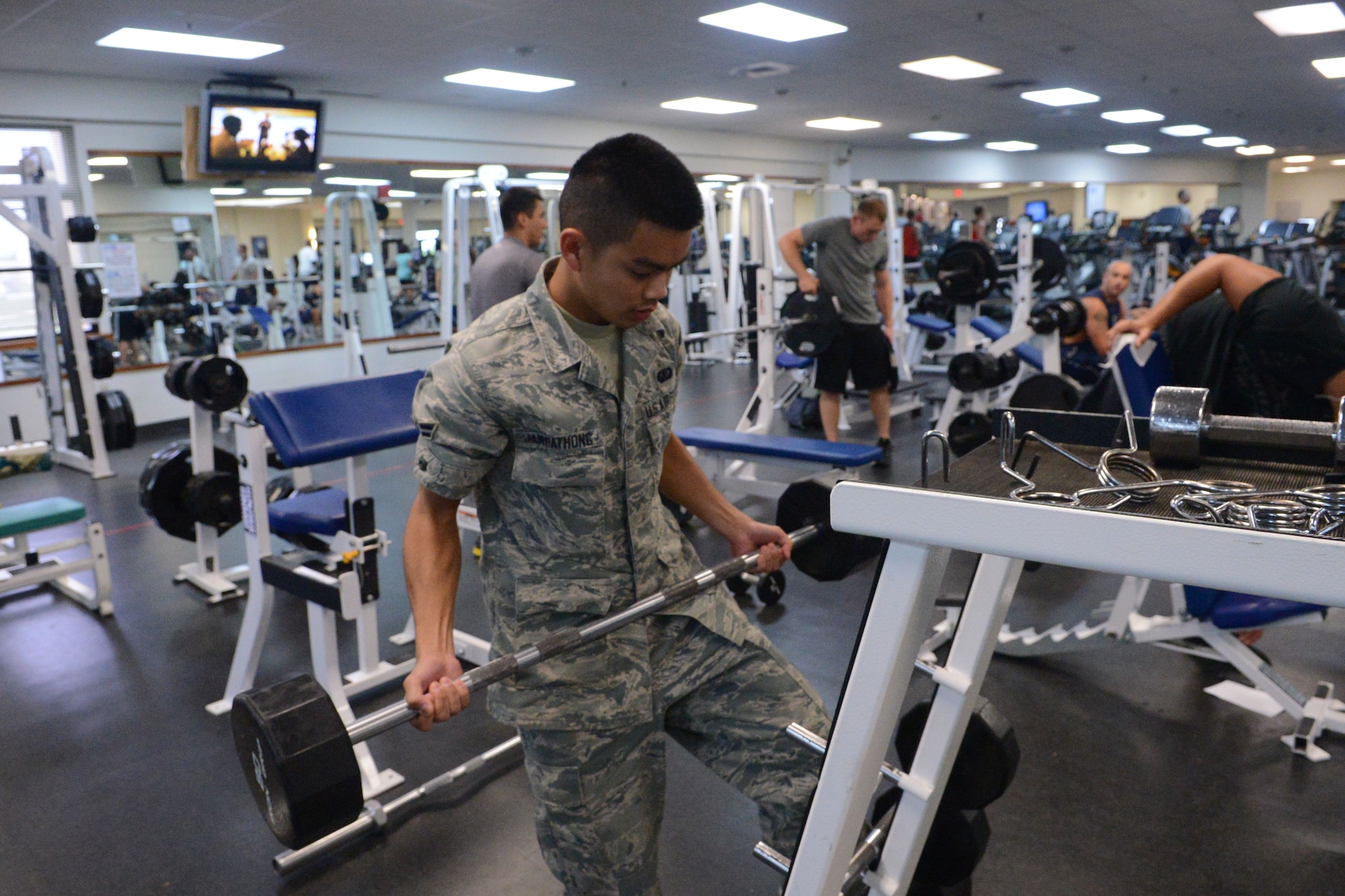 Airman 1st Class Andrew Jampathong, 36th Force Support Squadron fitness specialist, returns weights to a rack as a part of Coral Reef Fitness Center’s hourly checklist Sept. 6, 2013, on Andersen Air Force Base, Guam. Fitness specialists keep the facility running smoothly by maintaining the machines, cleaning all equipment and ensuring the equipment is in its proper place. (U.S. Air Force photo by Airman 1st Class Emily A. Bradley/Released)