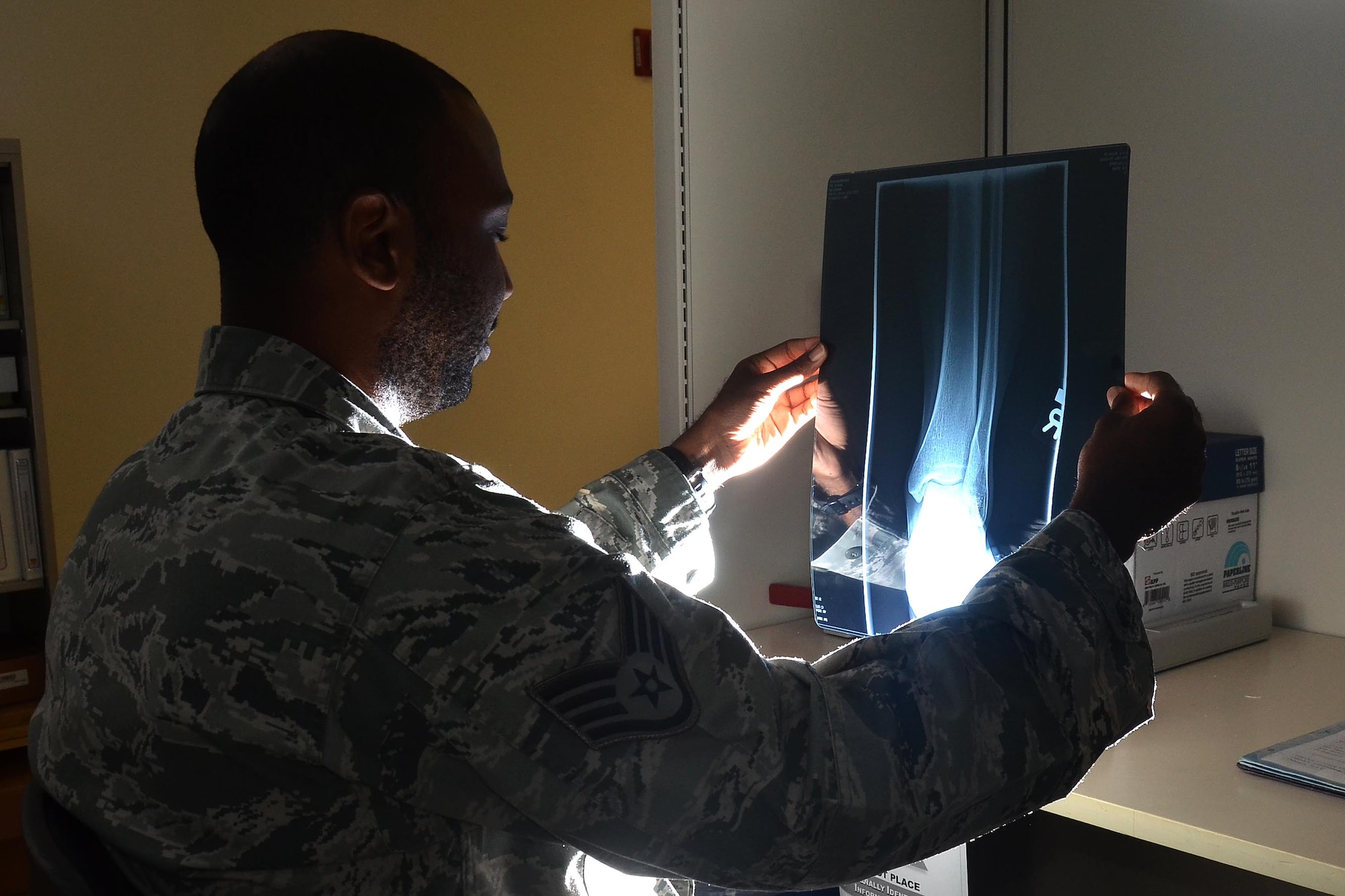 Staff Sgt. Jahmal Nicholas, 36th Medical Support Squadron NCO in charge of diagnostics imaging, reviews an x-ray of a patient’s ankle Aug. 4, 2013, on Andersen Air Force Base, Guam. An x-ray allows a more in-depth look into any anomalies the patient may have. A doctor will typically start in-depth testing with a standard X-ray, but will rely on a CT scan or an MRI depending on the results. (U.S. Air Force photo illustration by Airman 1st Class Mariah Haddenham/Released)