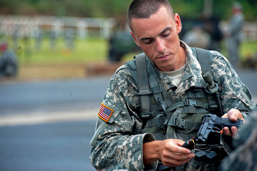 Army Spc. Joseph Miller uses a lighter to dull the finish on the sights of an M9 pistol while participating in the Winston P. Wilson Markmanship Competition on Camp Joseph T. Robinson, Ark., Sept. 2, 2013. Miller, a whelled vehicle mechanic, is assigned to the Illinois Army National Guard's Headquarters Company, 232nd Combat Support Sustainment Battalion.
