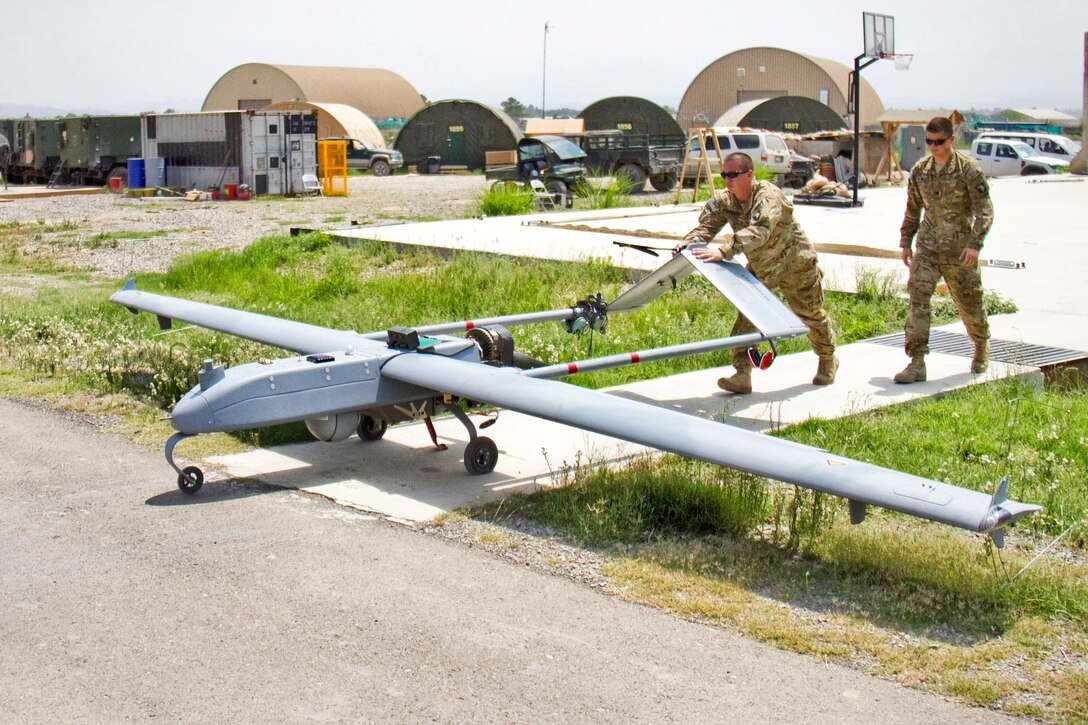 U.S. Army Spc. Jefferic S. Brinkley, left, and U.S. Army Spc. Nathan C. Phillips move an AAI RQ-7 Shadow to the pneumatic launcher before takeoff on Forward Operating Base Salerno, Khowst province, Afghanistan, Aug. 27, 2013. Brinkley and Phillips, unmanned aircraft system repairers, are assigned to the 101st Airborne Division's 4th Brigade Special Troops Battalion, 4th Brigade Combat Team.