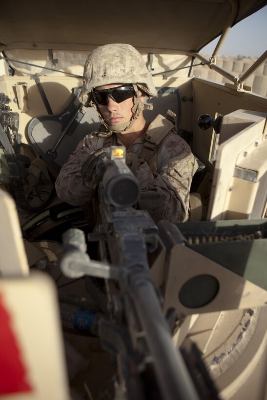 Lance Cpl. Dustin Dodd, a Habersham, Ga., native and turret gunner with Combat Logistics Regiment 2, Regional Command (Southwest), poses for  a photo in his gun turret after a combat logistics patrol in Helmand province, Afghanistan, Aug. 28, 2013. Dodd commonly stands in the turret for more than eight consecutive hours at a time on convoys that can last for days.