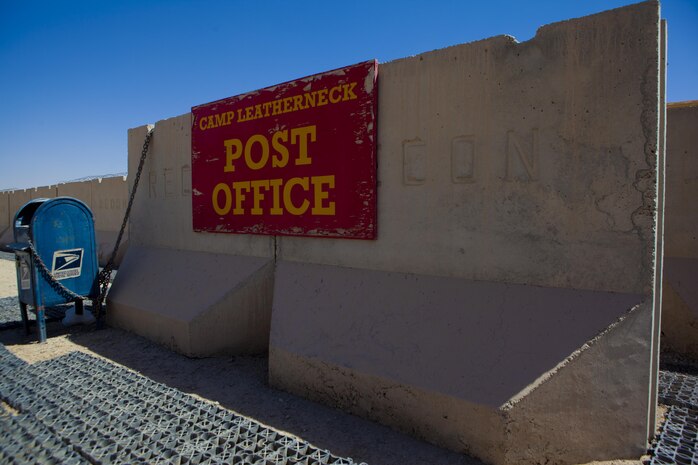 The front sign at the post office aboard Camp Leatherneck, Afghanistan, rests on a protective concrete barrier Sept. 1, 2013. Postal Marines with Combat Logistics Regiment 2, Regional Command (Southwest), recently upgraded the facility's postal equipment in an effort to improve service in the deployed environment.