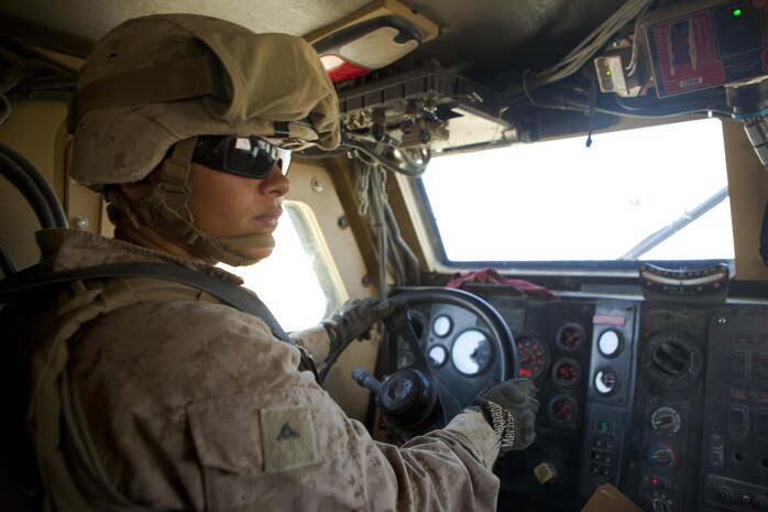 Lance Cpl. Morgan Almazan, an Arvada, Col., native and motor vehicle operator with Combat Logistics Regiment 2, Regional Command (Southwest), looks through the passenger side of her Mine Resistant, Ambush Protected vehicle during a convoy in Helmand province, Afghanistan, Aug 28. 2013. Almazan commonly drives for more than ten consecutive hours during convoys that can last for days.