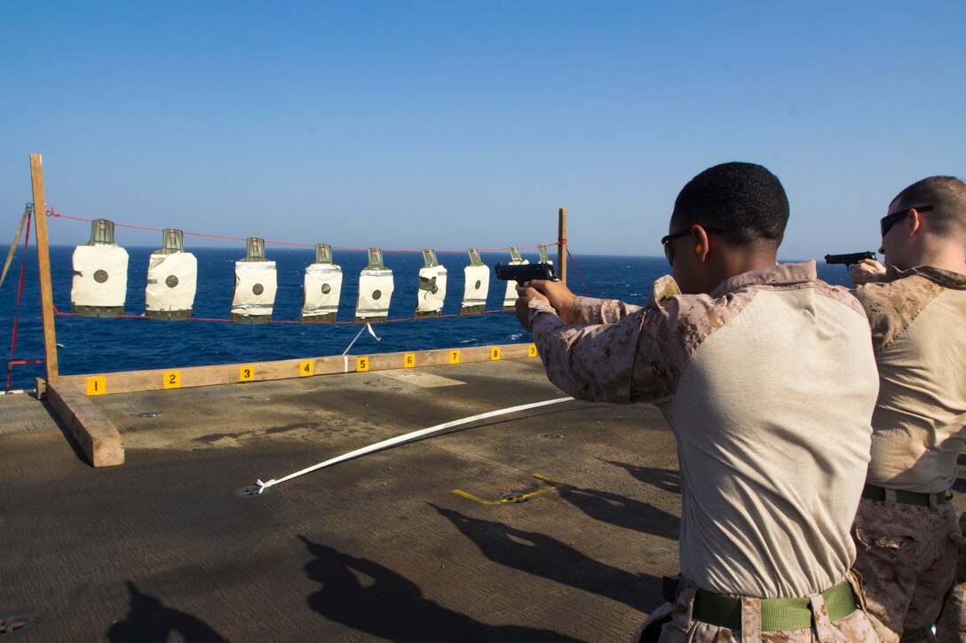 U.S. Marine Corps Cpl. Marque Avery with Combat Logistics Battalion 26, 26th Marine Expeditionary Unit (MEU), fires his M9 service pistol during a pistol qualification on the flight deck of the USS Kearsarge (LHD 3), at sea, Sept. 6, 2013. The 26th MEU is a Marine Air-Ground Task Force forward-deployed to the U.S. 5th Fleet area of responsibility aboard the Kearsarge Amphibious Ready Group serving as a sea-based, expeditionary crisis response force capable of conducting amphibious operations across the full range of military operations. (U.S. Marine Corps photo by Cpl. Kyle N. Runnels/Released)
