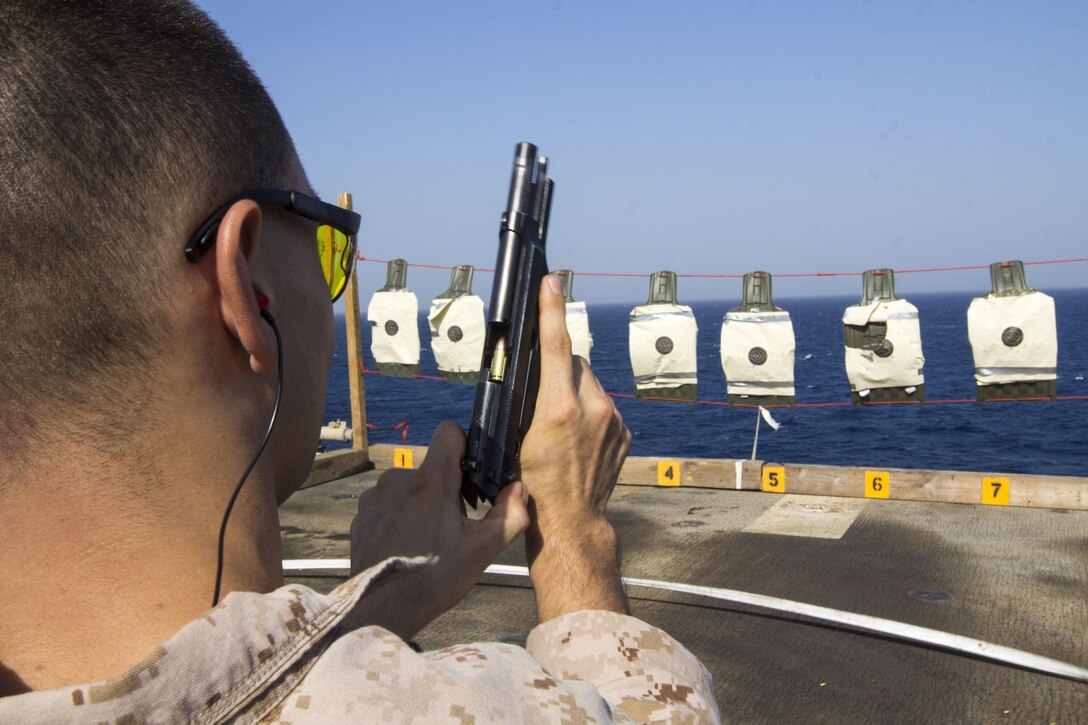 U.S. Marine Corps Cpl. Marcos Vidal with Combat Logistics Battalion 26, 26th Marine Expeditionary Unit (MEU), loads his M9 service pistol during a pistol qualification on the flight deck of the USS Kearsarge (LHD 3), at sea, Sept. 6, 2013. The 26th MEU is a Marine Air-Ground Task Force forward-deployed to the U.S. 5th Fleet area of responsibility aboard the Kearsarge Amphibious Ready Group serving as a sea-based, expeditionary crisis response force capable of conducting amphibious operations across the full range of military operations. (U.S. Marine Corps photo by Cpl. Kyle N. Runnels/Released)
