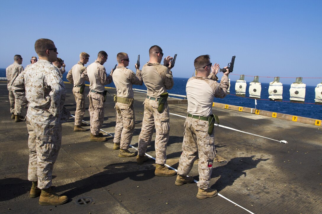 U.S. Marines assigned to Combat Logistics Battalion 26, 26th Marine Expeditionary Unit (MEU), conduct a pistol qualification with an M9 service pistol on the flight deck of the USS Kearsarge (LHD 3), at sea, Sept. 6, 2013. The 26th MEU is a Marine Air-Ground Task Force forward-deployed to the U.S. 5th Fleet area of responsibility aboard the Kearsarge Amphibious Ready Group serving as a sea-based, expeditionary crisis response force capable of conducting amphibious operations across the full range of military operations. (U.S. Marine Corps motion media by Cpl. Kyle N. Runnels/Released)
