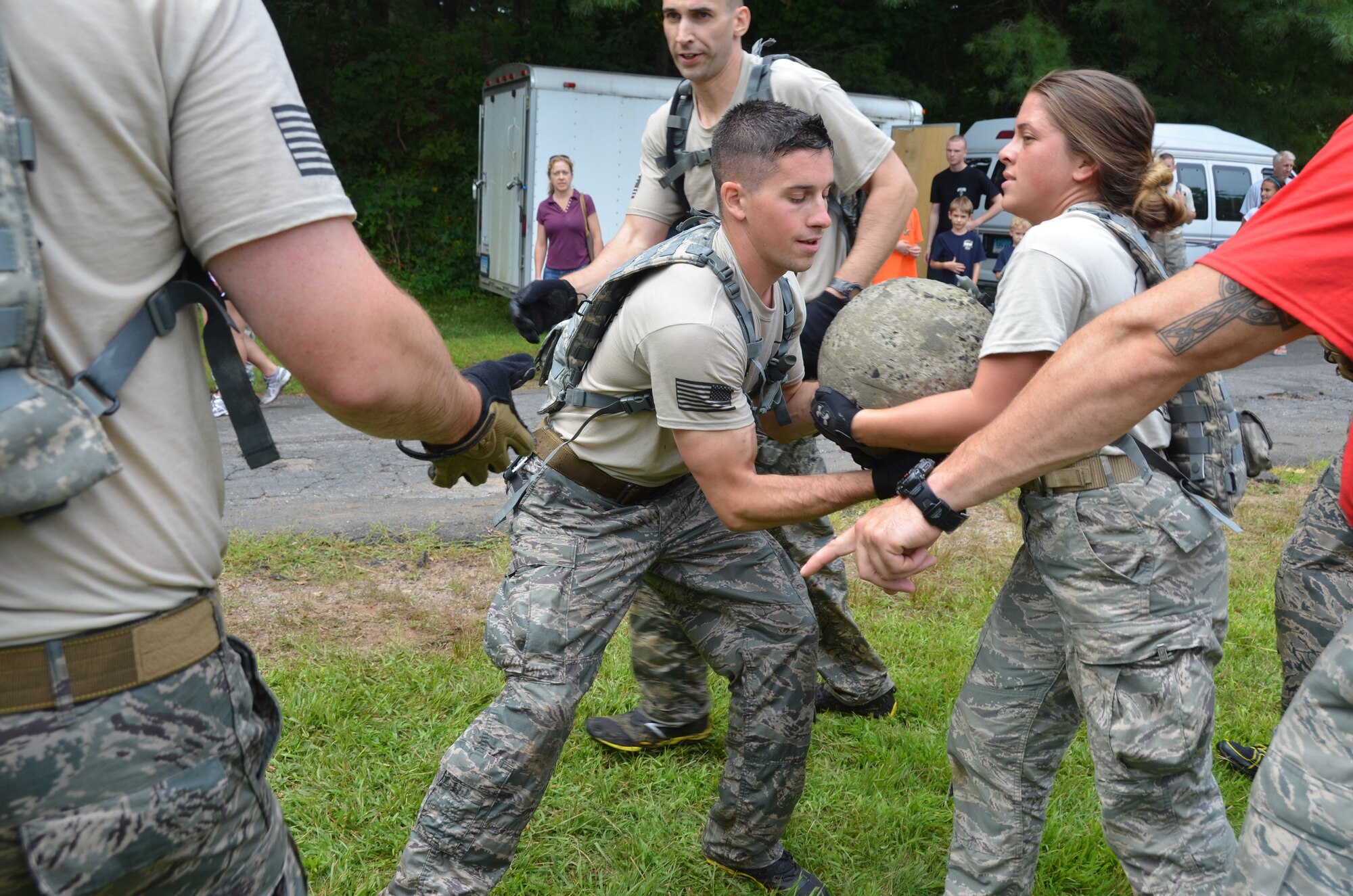 Members of the 103rd Security Forces Squadron emergency services team work together to move a heavy stone as part of the Connecticut SWAT Challenge on Aug. 22, 2013, at the West Hartford Reservoir, West Hartford, Conn. The Connecticut Air National Guard team grabbed eighth place overall, besting 20 other regional teams. This was just one of many physically grueling obstacles competitors faced.  (U.S. Air National Guard Photo by Maj. Bryon Turner)