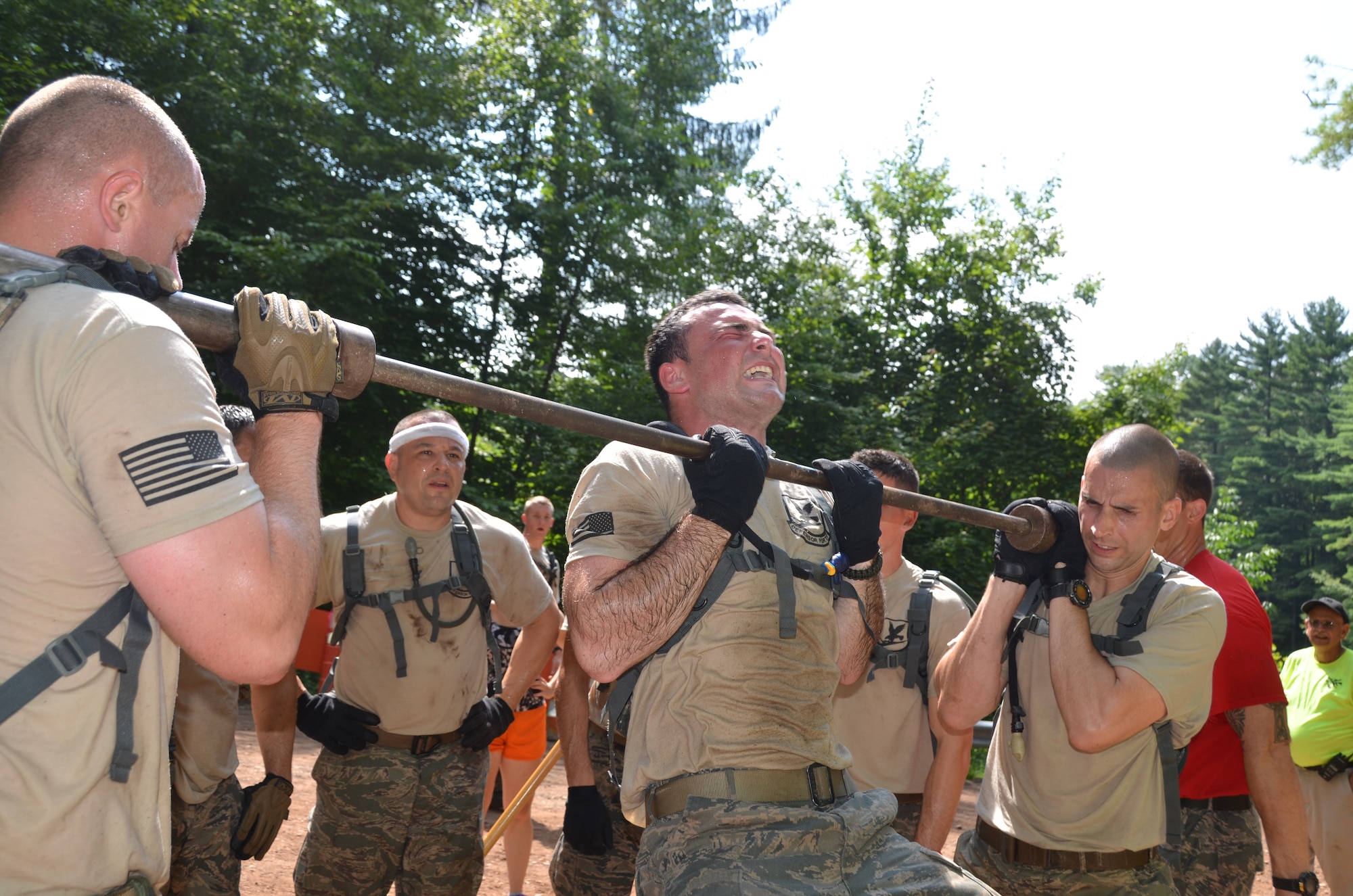 Senior Airman Francis Gelada, 103rd Security Forces Squadron, grimaces during a pull-up as his teammates hold the bar in place as part of the Connecticut SWAT Challenge on Aug. 22, 2013, at the West Hartford Reservoir, West Hartford, Conn. The Connecticut Air National Guard team grabbed eighth place overall, besting 20 other regional teams. (U.S. Air National Guard Photo by Maj. Jefferson S. Heiland)