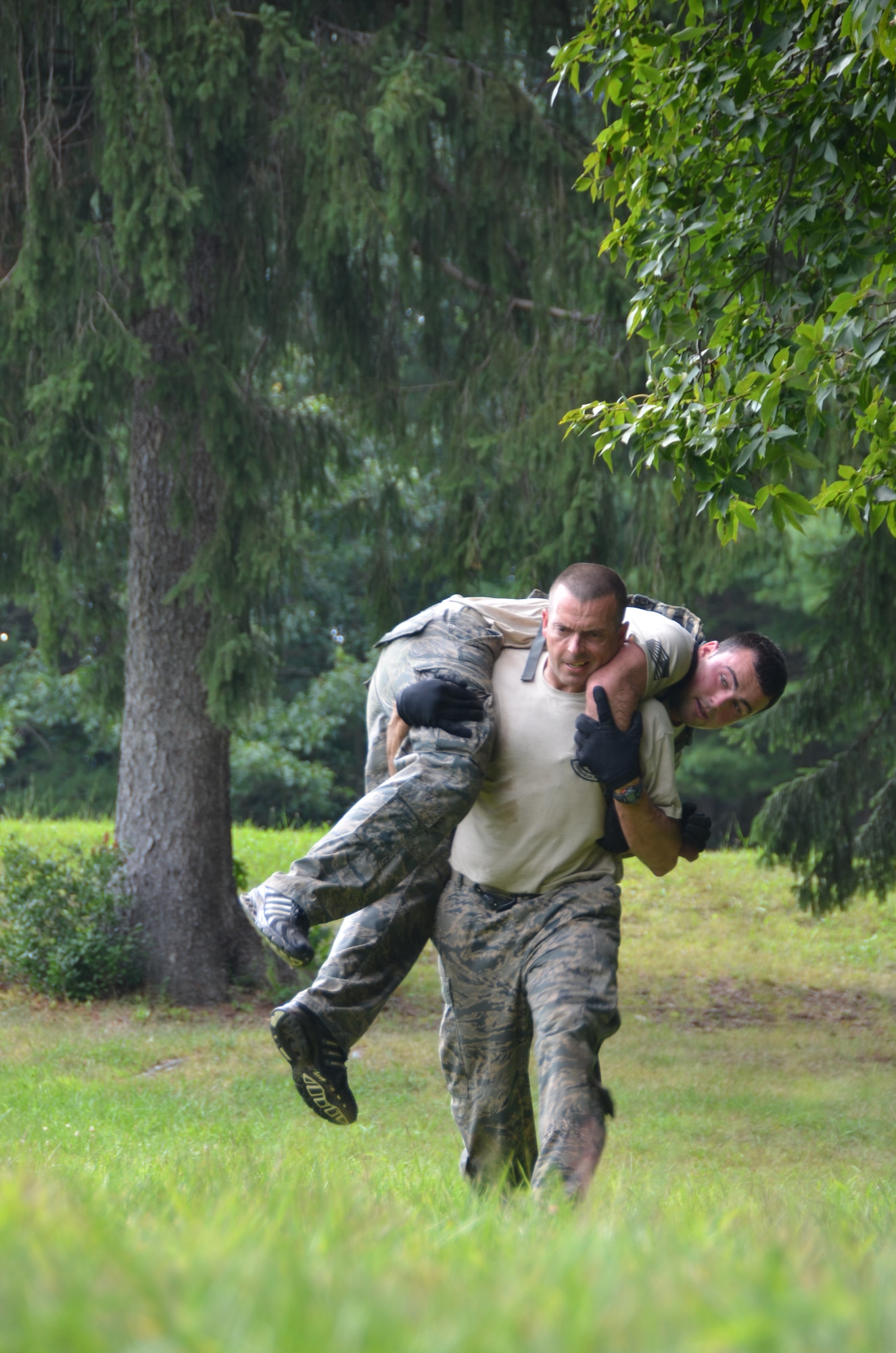 Senior Airman Jason Dufour carries Senior Airman Francis Gelada as part of just one of a myriad of physical challenges at the West Hartford Reservoir in West Hartford, Conn. during the ninth annual Connecticut SWAT Challenge Aug. 22, 2013. The team from the 103rd Security Forces Squadron came in eighth place overall, besting 20 other regional teams from across New England. (U.S. Air National Guard Photo by Maj. Jefferson S. Heiland)