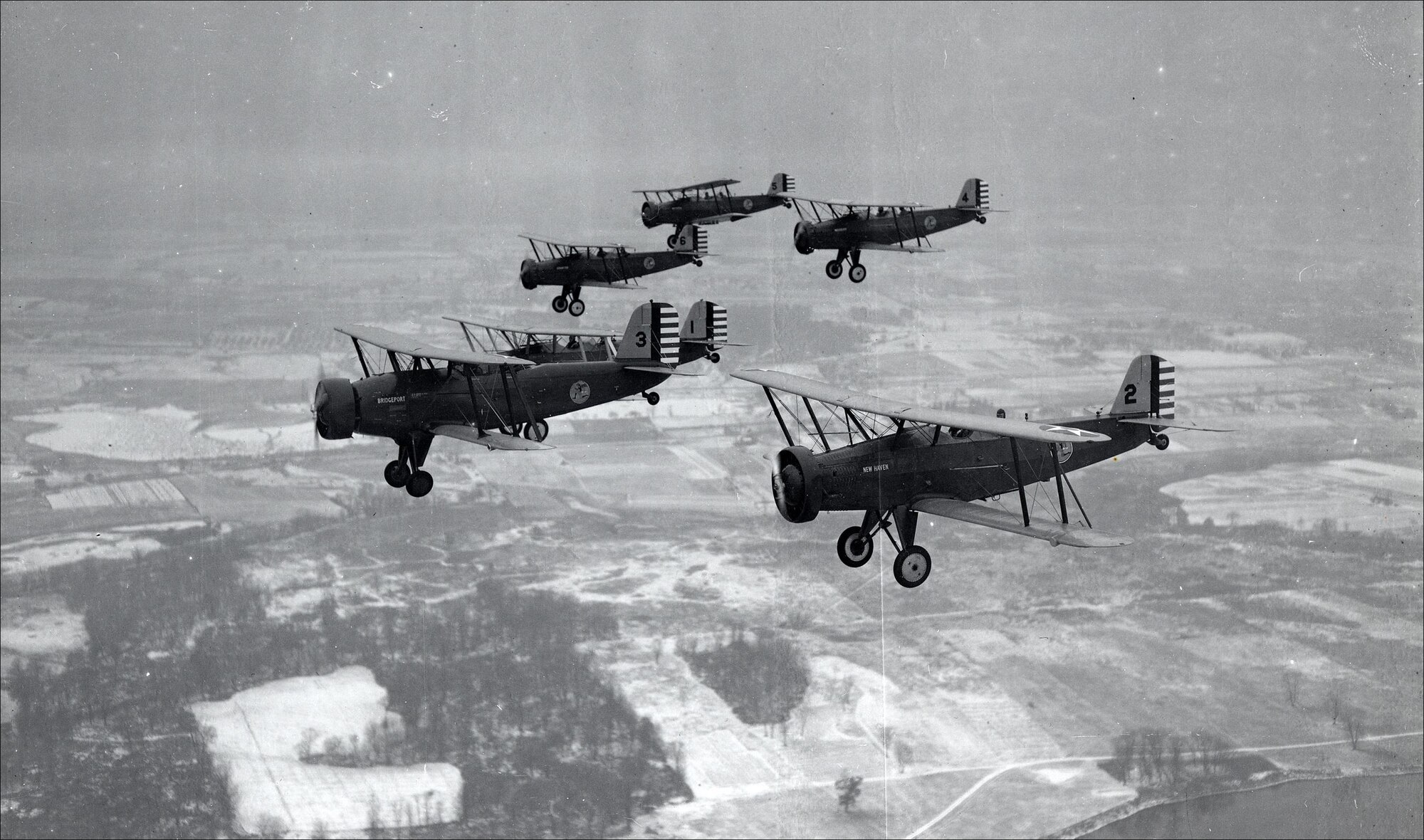 A formation of Douglas 0-38 aircraft emblazoned with the Flying Yankees insignia operated by aviators from the 118th Observation Squadron. The squadron flew the O-38 between 1931—1937. (U.S. Air National Guard file photo)