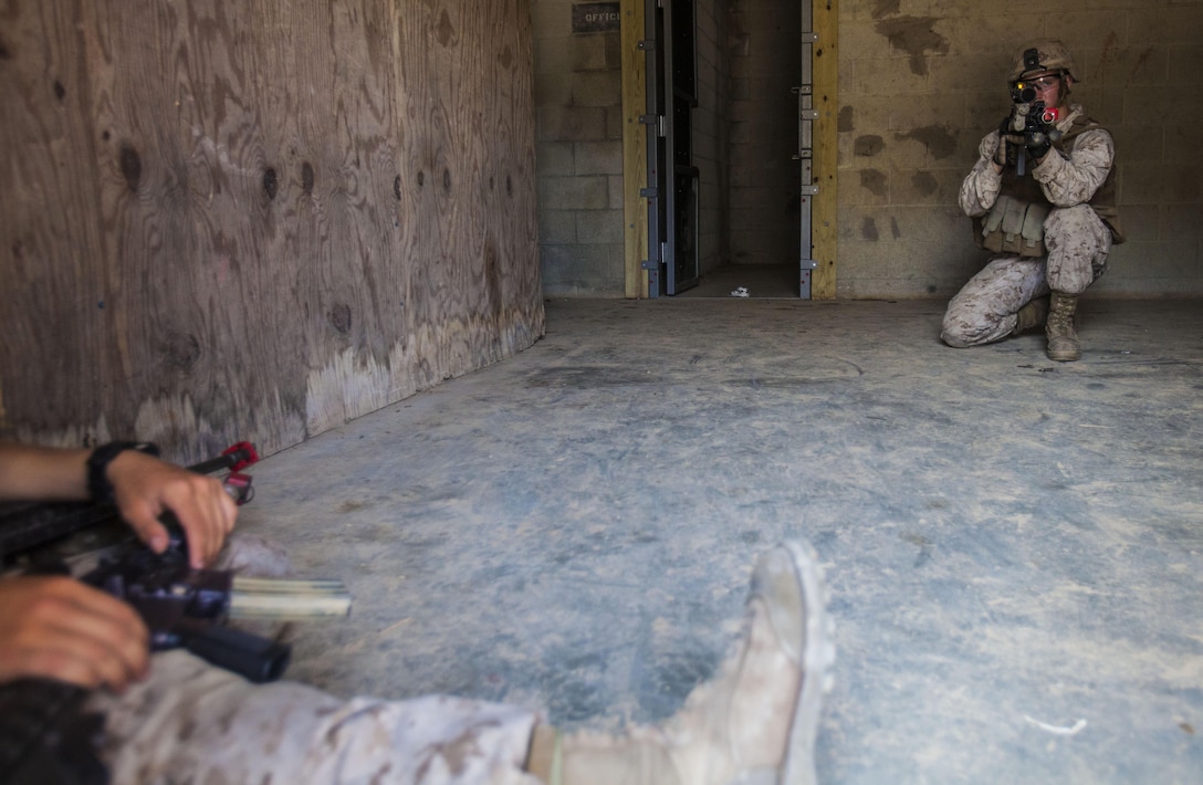 U.S. Marine Corps Lance Cpl. Cody Felker, Battalion Landing Team (BLT) 1st Battalion, 6th Marine Regiment, 22nd Marine Expeditionary Unit (MEU), squad automatic weapon gunner and native of Jeffersonville, Ind., provides security during urban tactics training as part of the MEU’s Realistic Urban Training exercise at Fort Pickett, Va., Aug. 31, 2013. More than 160 Marines from the BLT practiced fire team and squad-level room and building clearings before progressing to platoon-sized raids on a simulated town. The MEU is scheduled to deploy in early 2014 to the U.S. 5th and 6th Fleet areas of responsibility with the Bataan Amphibious Ready Group as a sea-based, expeditionary crisis response force capable of conducting amphibious missions across the full range of military operations. (U.S. Marine Corps photo by Sgt. Austin Hazard/Released)